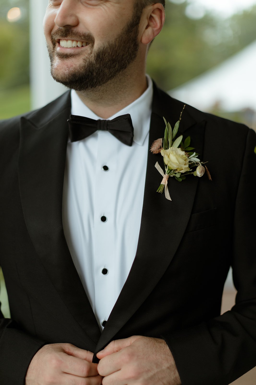 groom-in-tux-with-bow-tie-and-whimsicle-wild-unstructured-boutonniere-with-pale-fall-colors.jpg