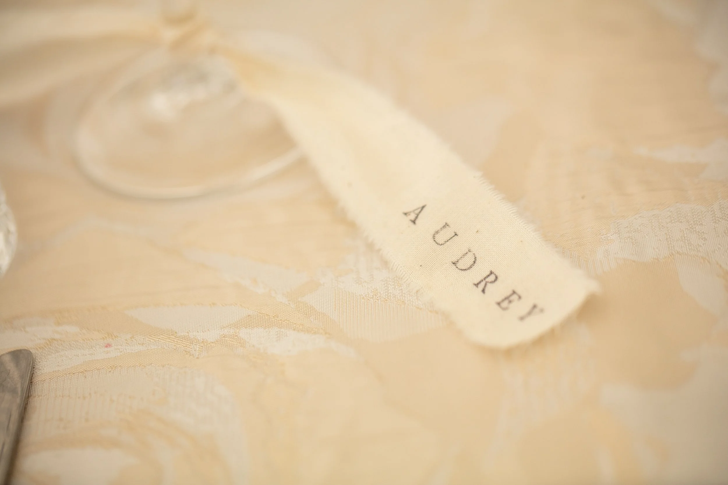 fabric-ribbon-place-cards-tied-to-wine-glass.jpg