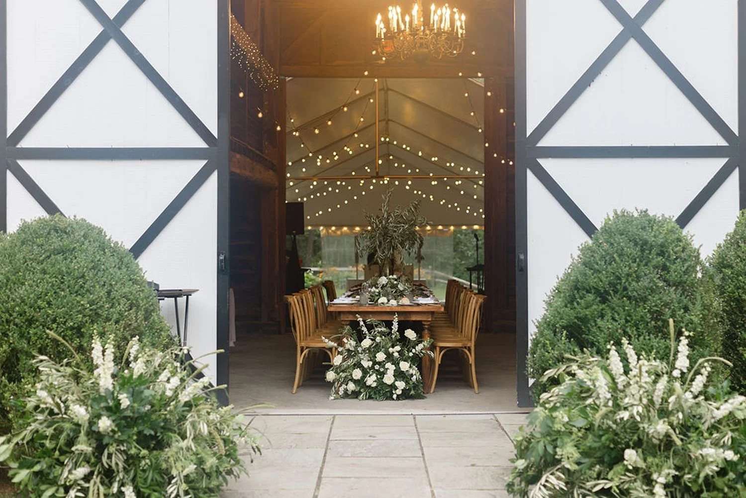 wedding-barn-entrance-with-repurposed-ceremony-flowers.jpg