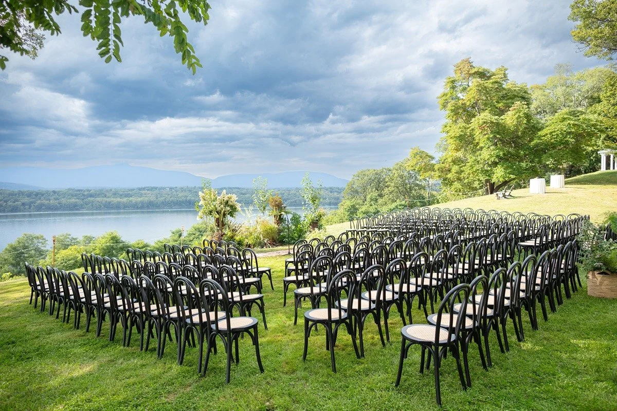 hudson-valley-wedding-planner-ceremony-setup-with-black-curved-wood-chairs-overlooking-hudson-river