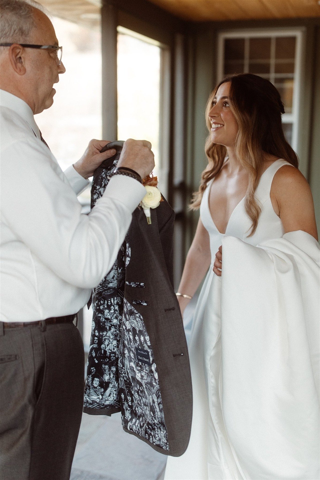 Father-Of-The-Bride-During-First-Look-Showing-Her-His-Custom-Jacket-Liner-For-The-Wedding