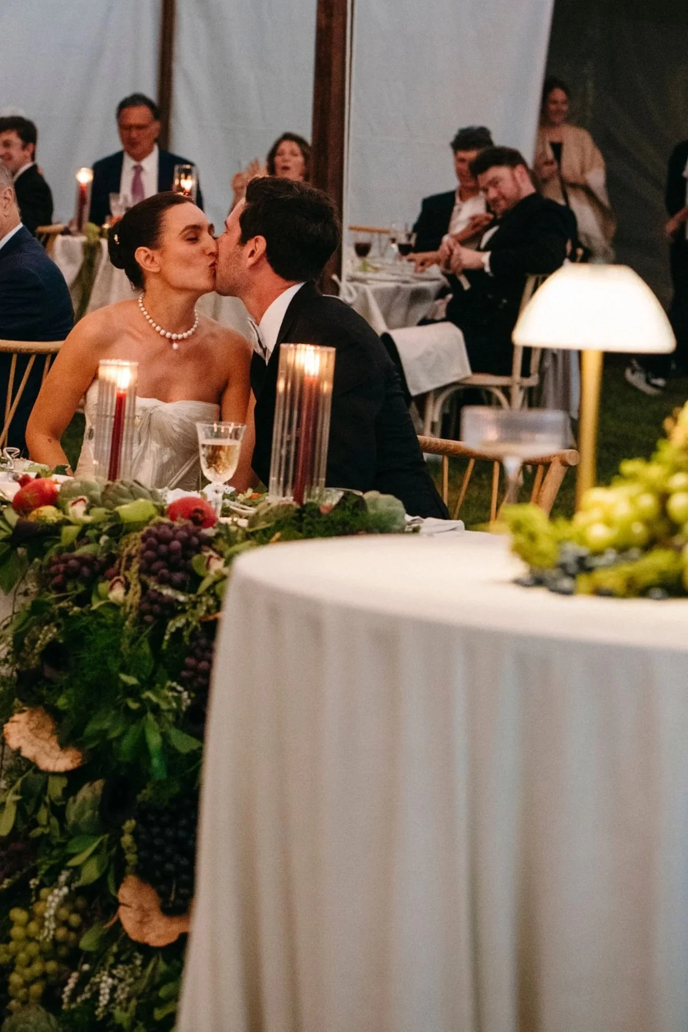 sailcloth-tent-wedding-etherial-candles-battery-operated-lamp-grapes-figs-and-the-couple-kissing.jpg