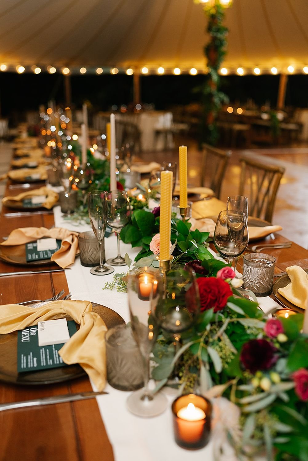 flameless-votive-candles-in-amber-glass-at-tented-wedding-reception.jpg