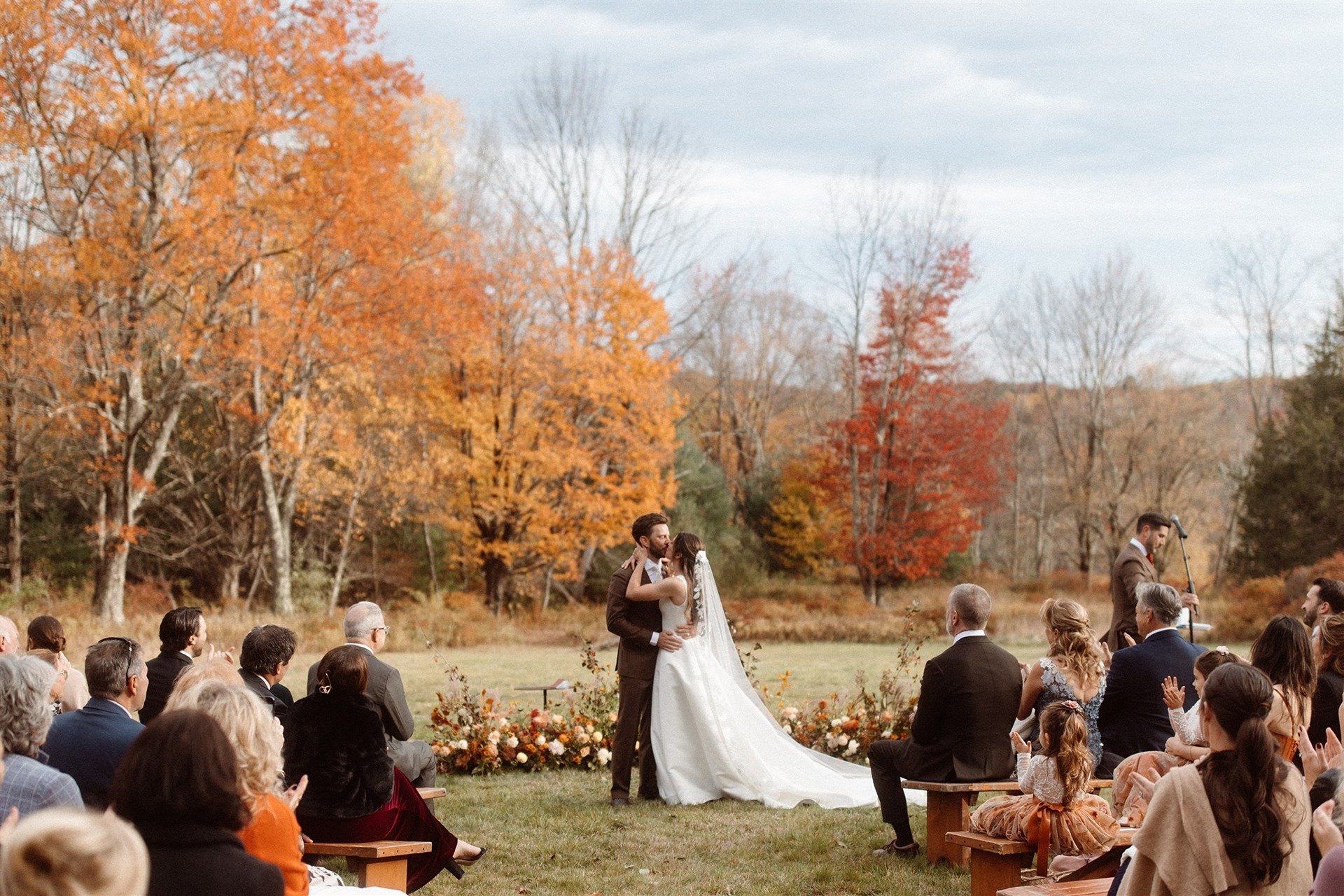 Bride-And-Groom-Having-Their-First-Kiss-At-Their-Autumn-Outdoor-Ceremony-At-Hemlock-Neversink