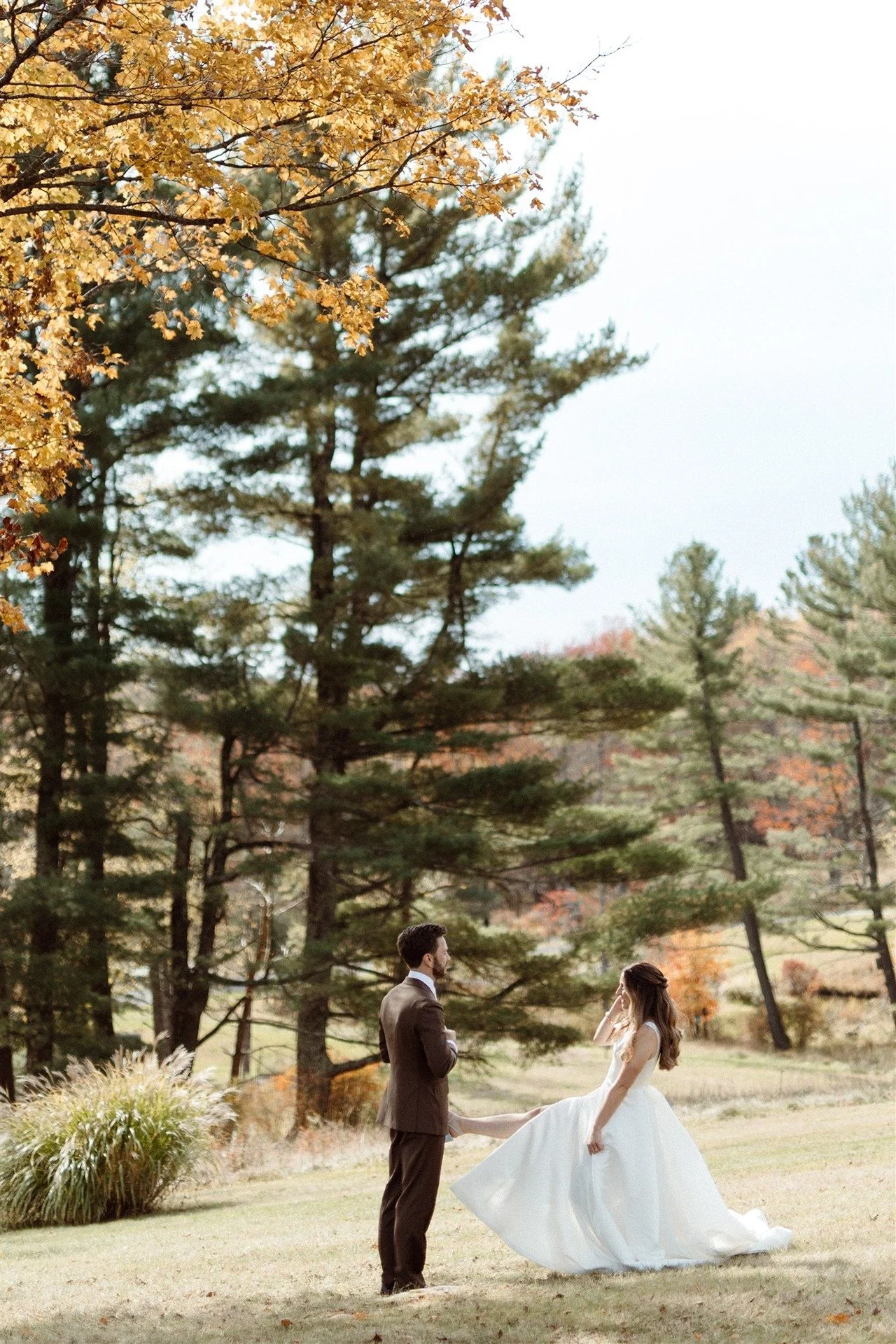 Hemlock-Neversink-Hudson-Valley-Wedding-Bride-Showing-Off-Her-Dress-To-Groom-During-First-Look