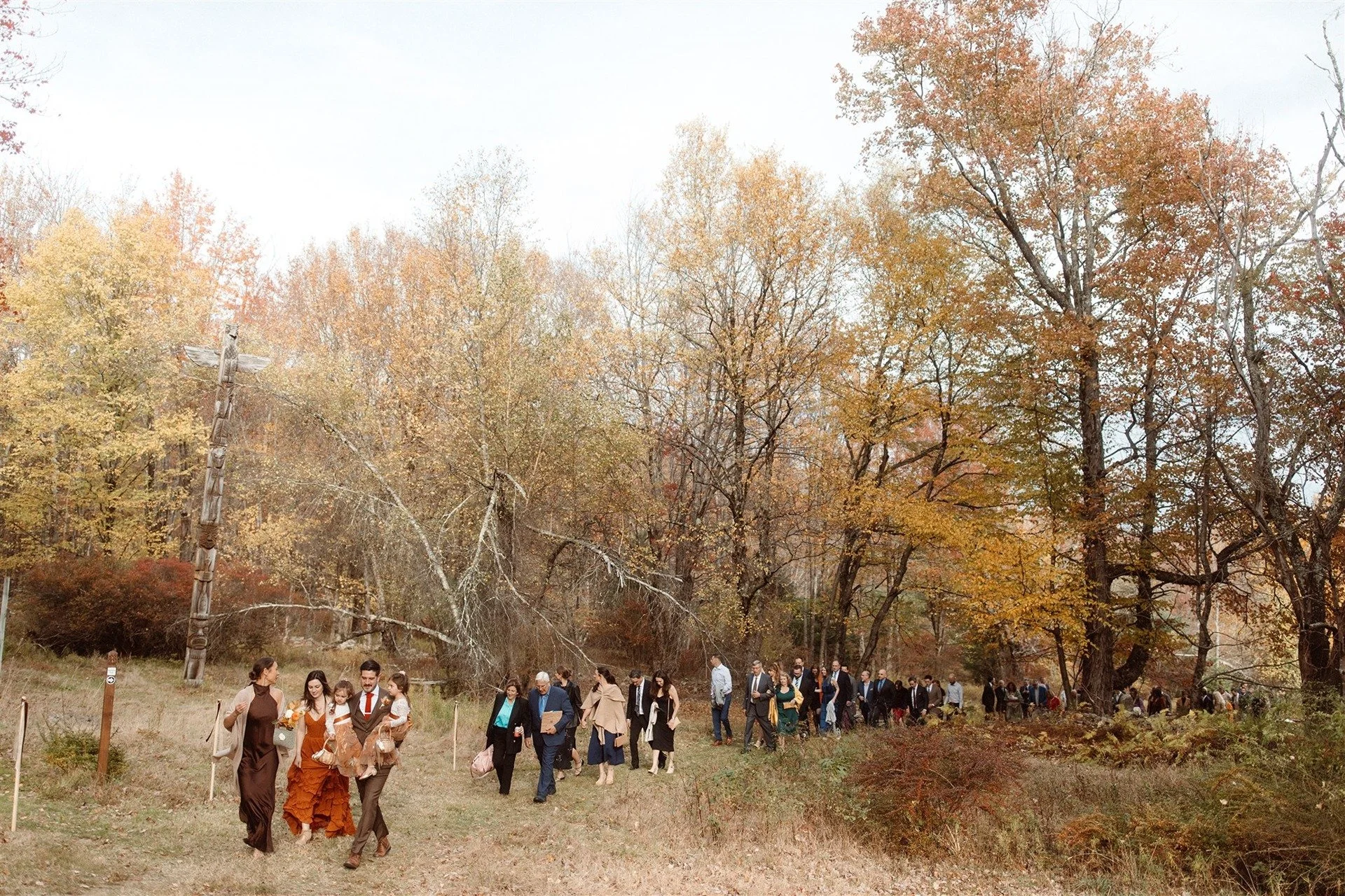 Outdoor-Fall-Wedding-Guests-Walking-From-Ceremony-Up-To-Cocktail-Hour-At-Hemlock-Neversink-New-York