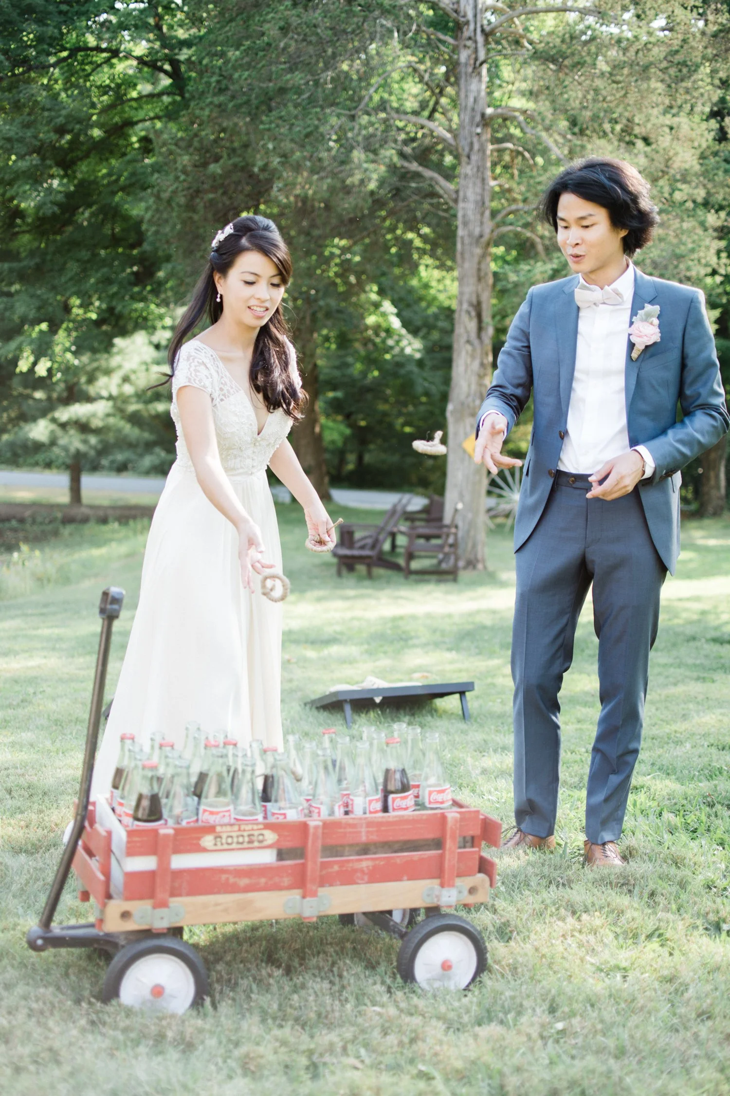 bride-and-groom-playing-ring-toss-game-at-their-elizaville-ny-wedding-in-upstate-ny-using-mexican-coke-bottles