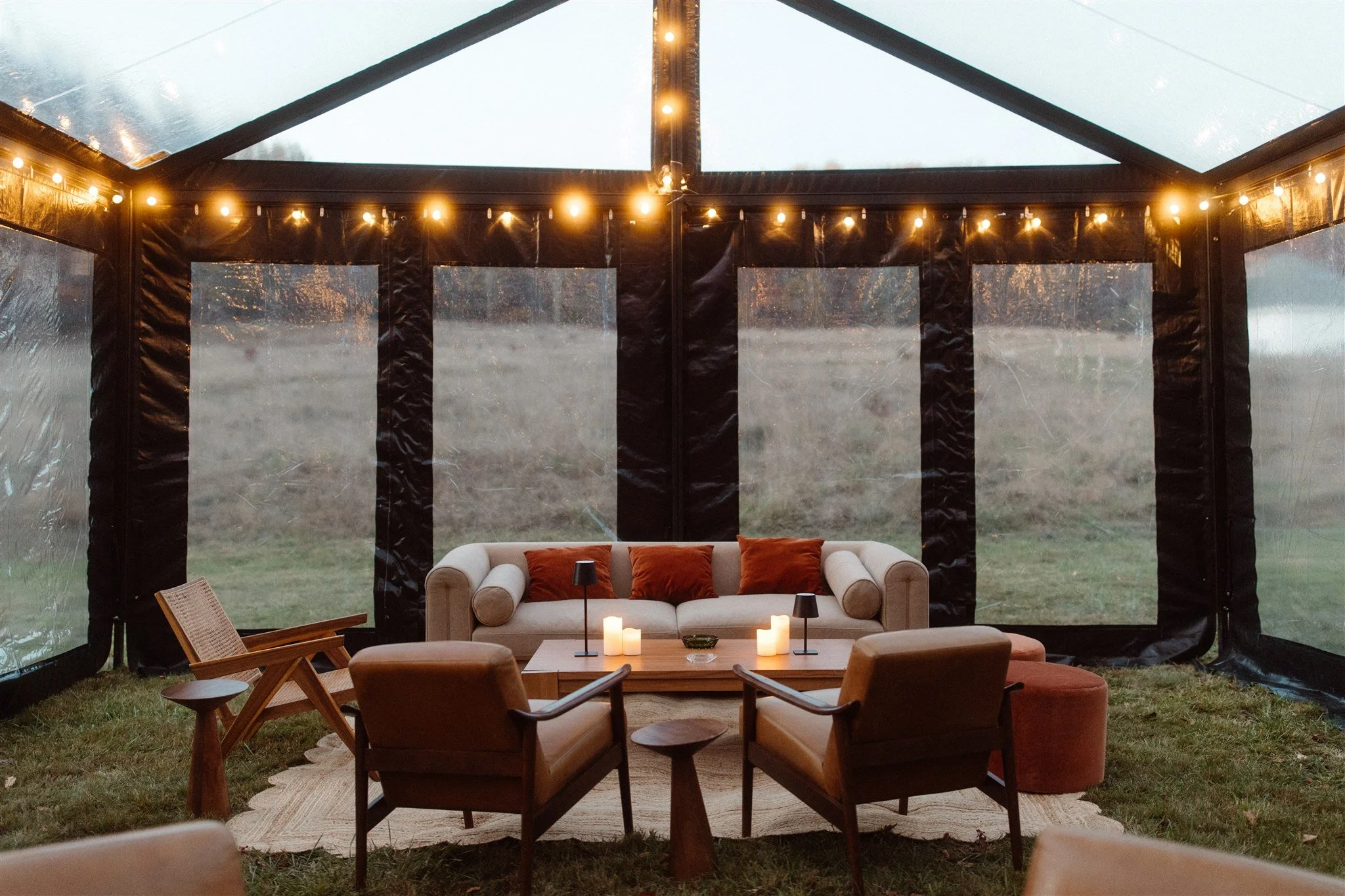 patina-rentals-hudson-valley-wedding-planner-lounge-under-clear-structure-tent-extension-using-flameless-battery-candles-in-a-cigar-lounge.jpg