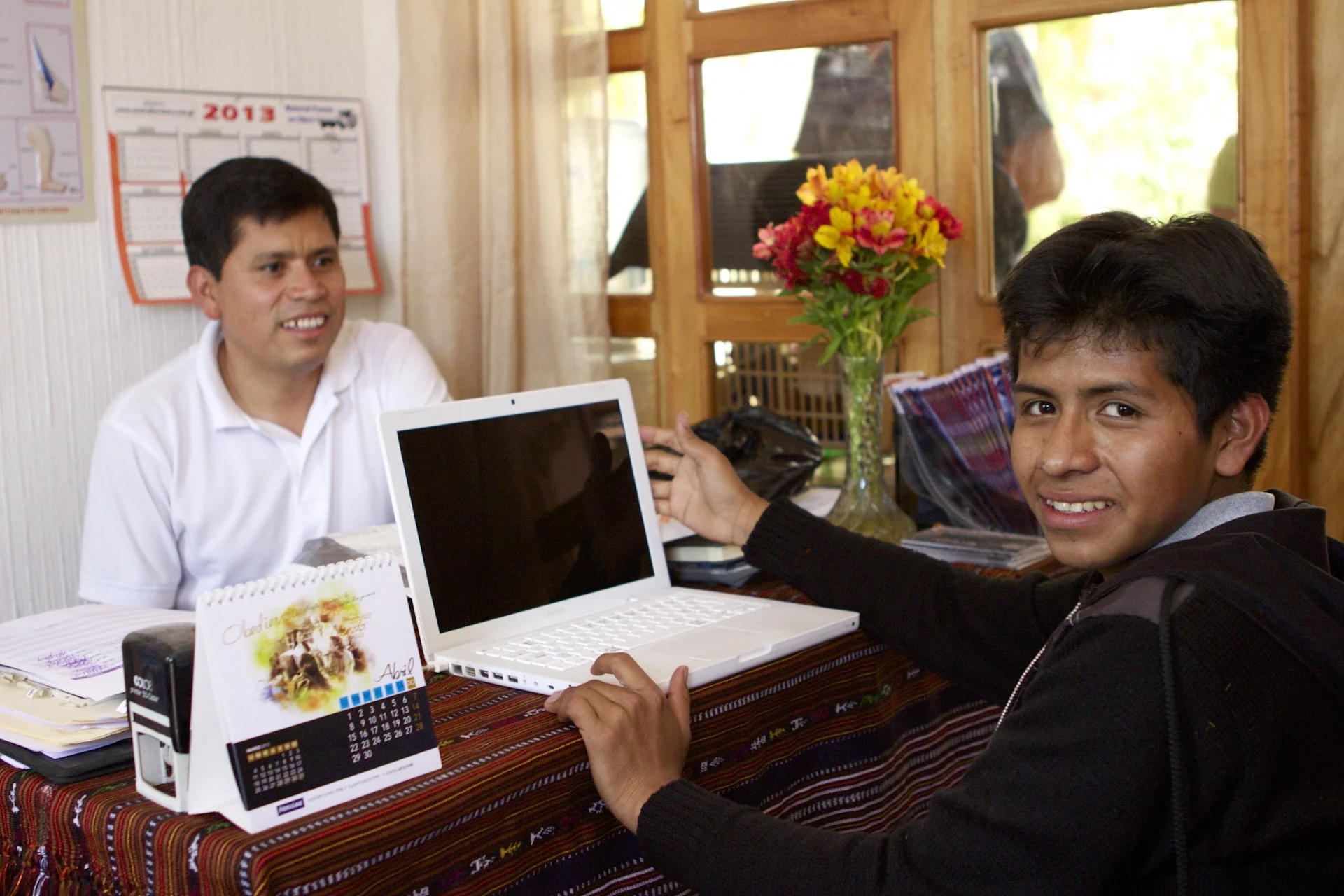 Gregorio with student Juan Antonio, who has become a computer expert in repair and networking, hosting a mini-internet-cafe in his home, and now studying systems engineering in university. Before the scholarship, he had never touched a computer.