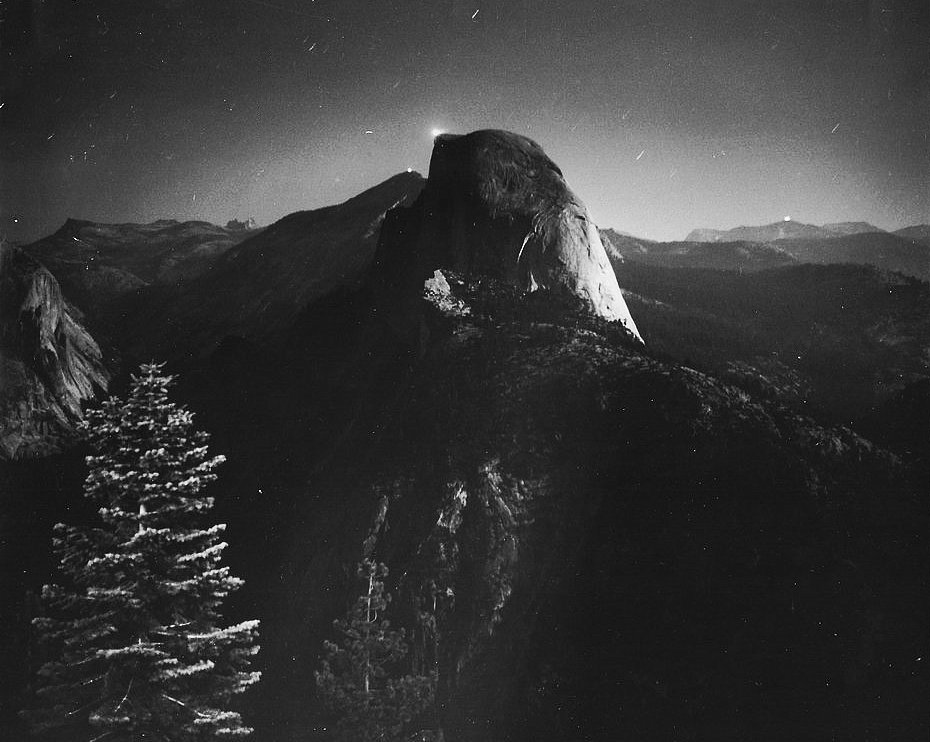 The flares on Mount Lyall, Clouds Rest and half Dome, with a full moon above