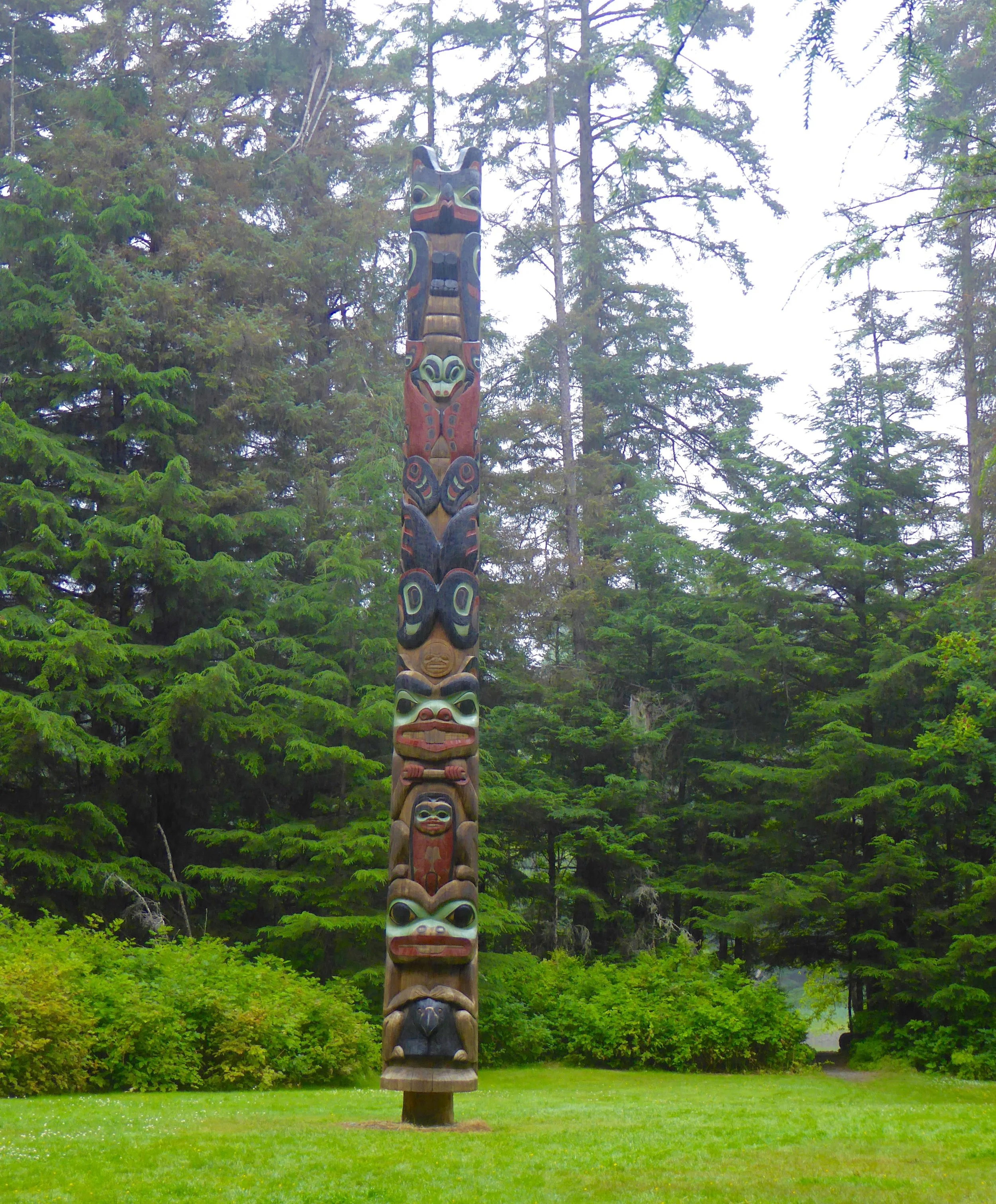 Many totem poles were displayed thru out the forest.