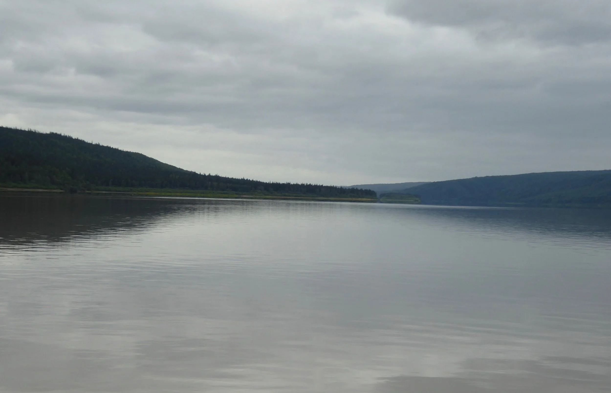 Soon we pull into Tanana, where Don hopes to get water and maybe connect to the internet. A small grocery store provides him with two apples, some crackers and water from their sink. The washerteria is closed today so no showers or laundry today. There is cell service in this part of the river, but you must have GCI. Our provider is not a partner so once again we are not connected to the outside. We are carrying a satellite phone so if an emergency arrises we do have a communication device. It is raining on and off today. We have brought our heavy duty rain gear and wonder if we will need to pull it out. One of the reports that we read about traveling this section commented that one will need to be accustomed to being cold and wet.