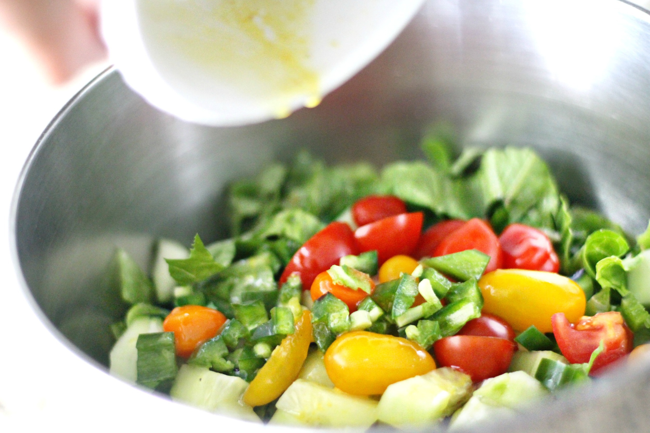 Pour in the whisked dressing into the salad bowl. Toss + mix it! I like my salads a bit over dressed so pour it in little by little to best suit you.