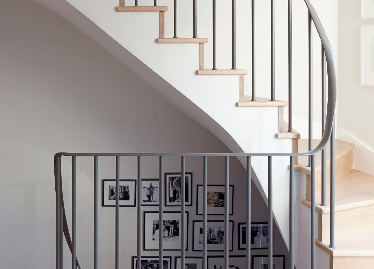 Jill Scholes Interior design, mews house, staircase with metal balustrade and family photo gallery