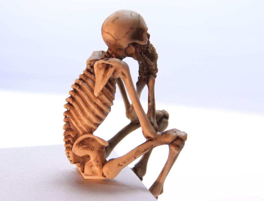 The all too common skeleton in a seated position.
