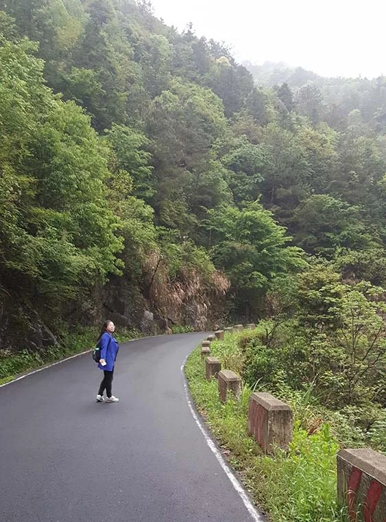 Xie Xiaoyan takes her morning stroll near her village in the mountains.