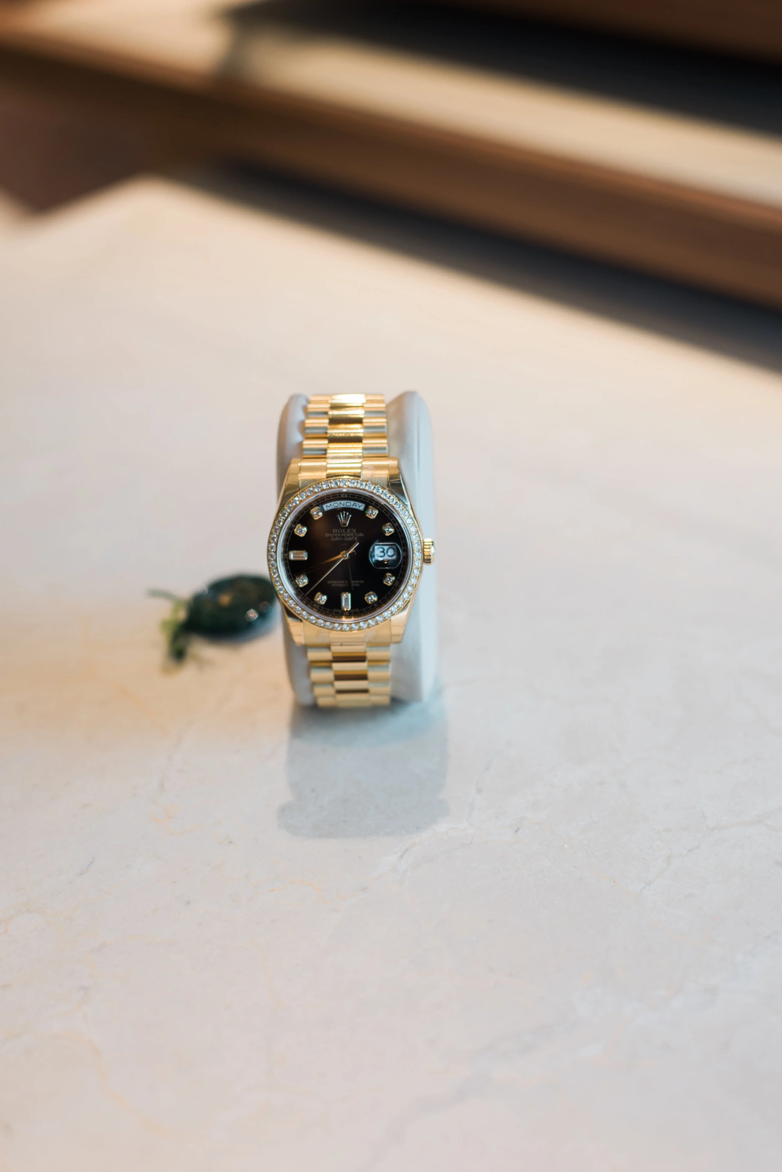 (Rolex 18K yellow gold Day Date with black diamond dial and full diamond bezel.)