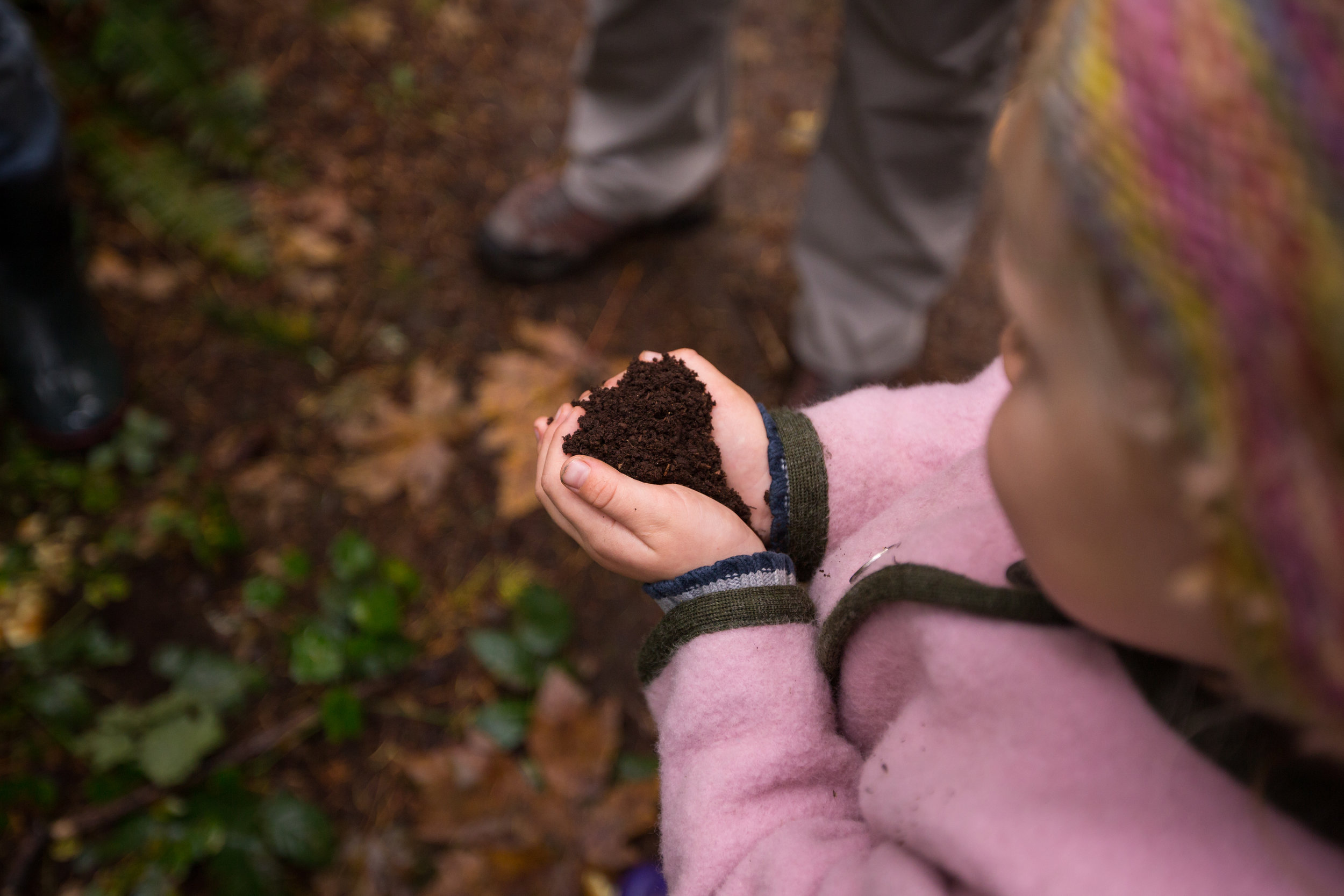 girl holding handful of dirt