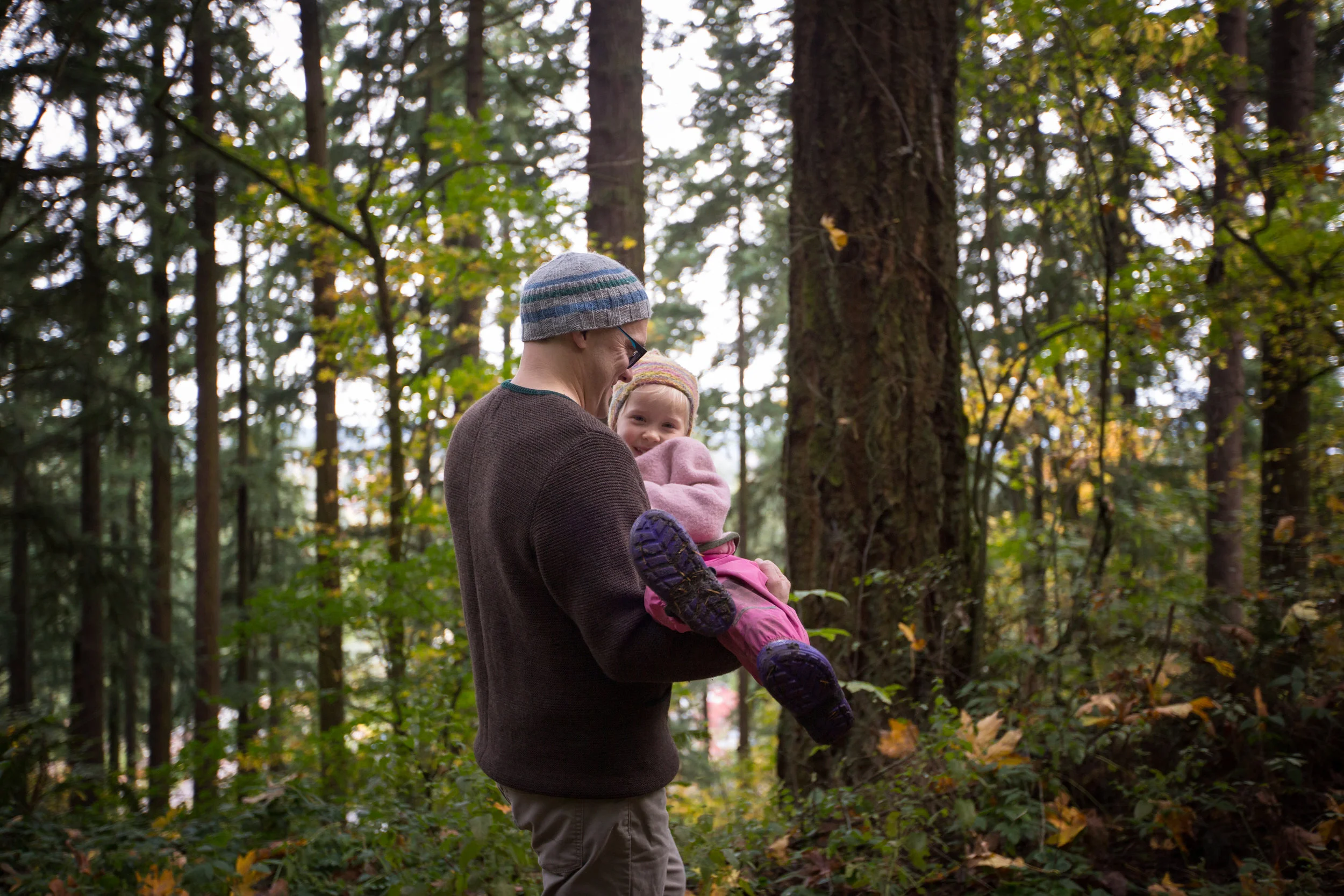 dad carrying daughter with grin