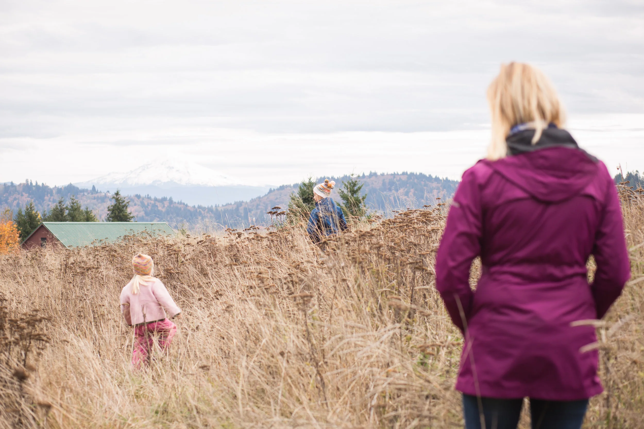 mom watching children in field