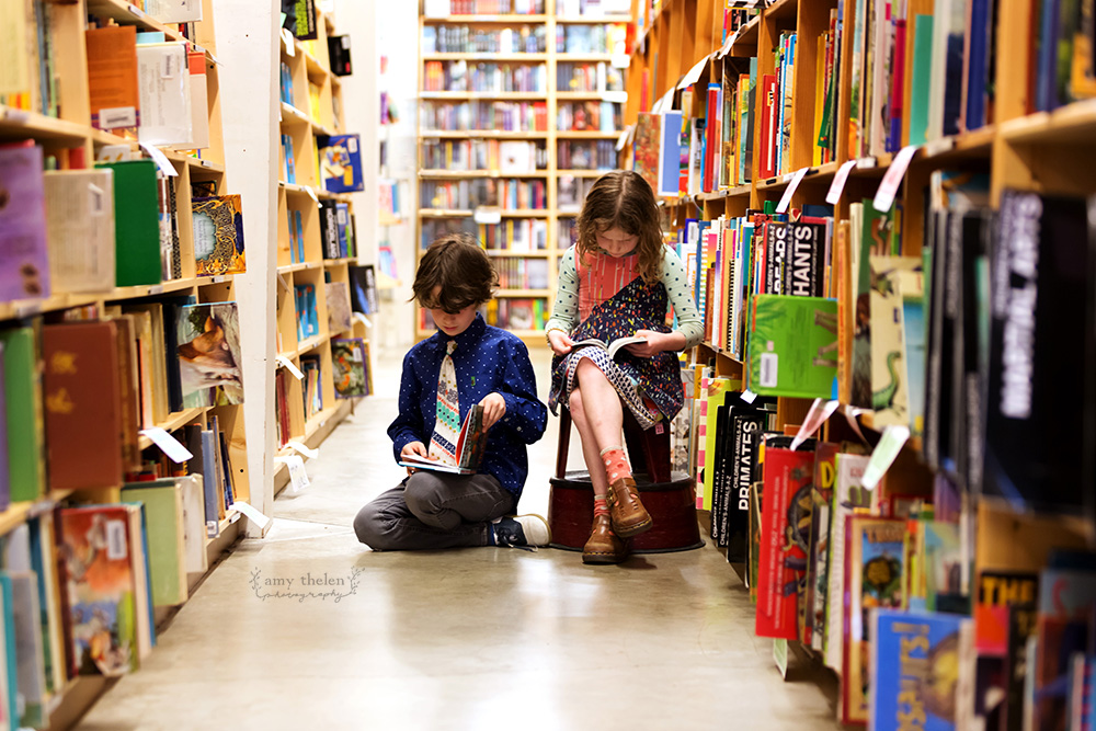 girl and boy Powell's Bookstore aisle