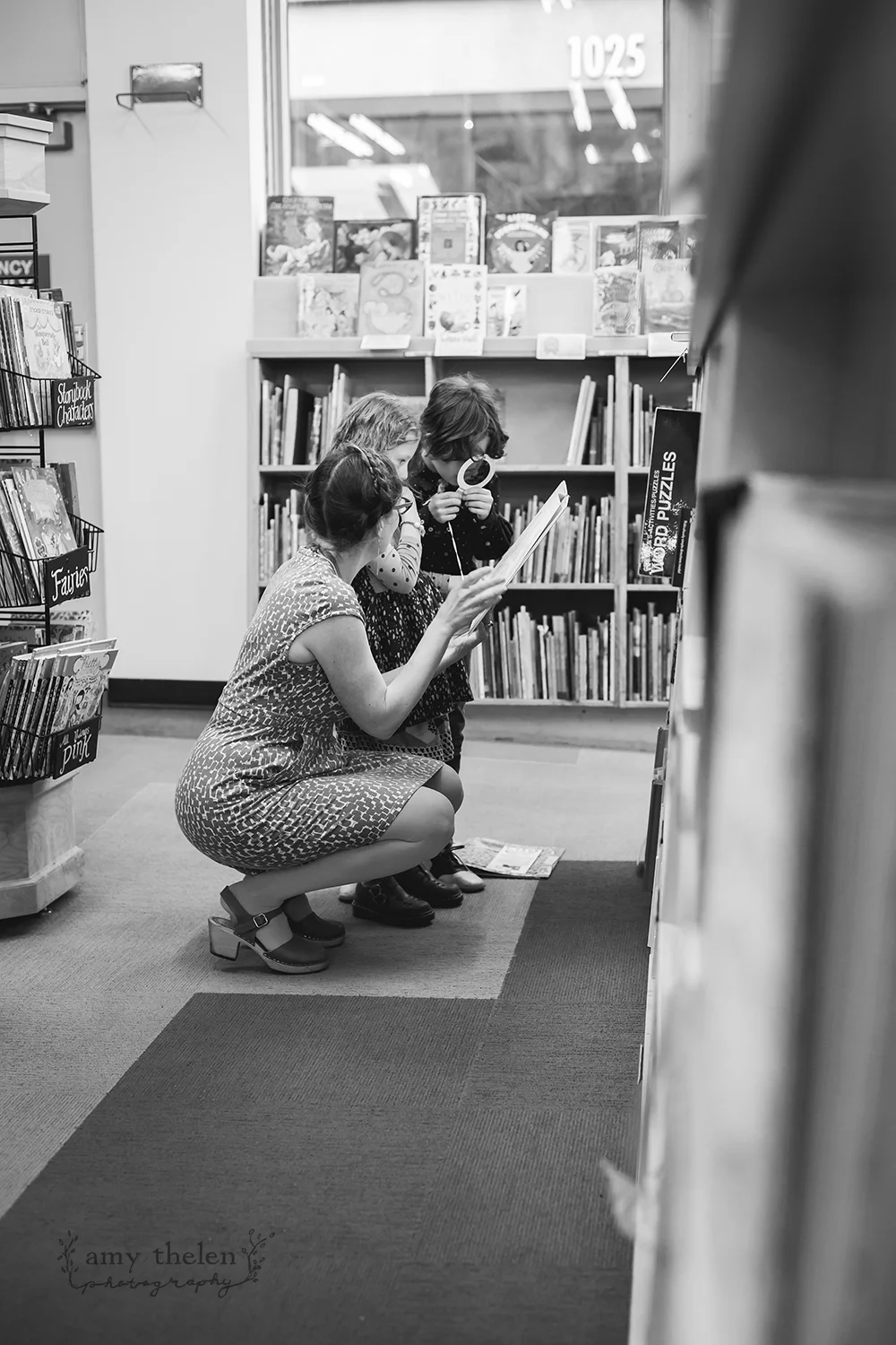 kids and mom looking at book together