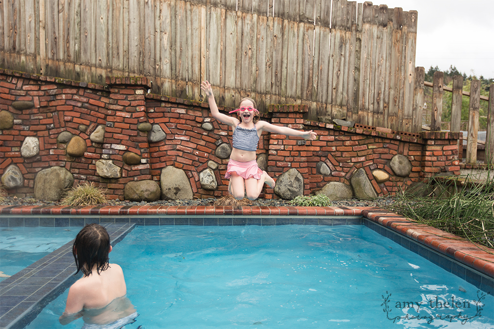 girl with goggles jumping