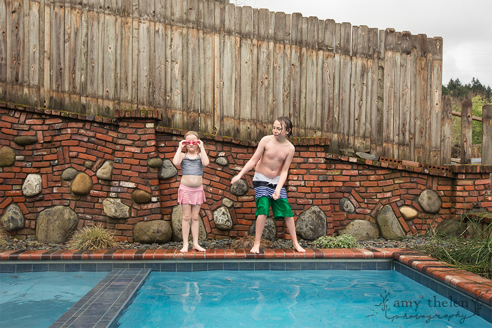 girl and boy dancing near pool