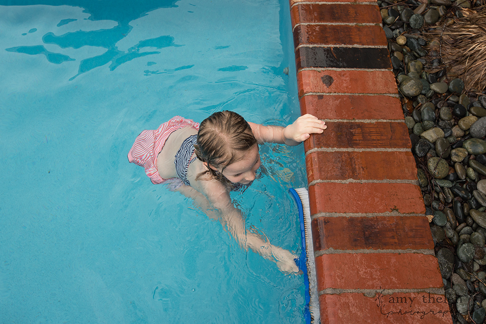 girl scrubbing pool edge