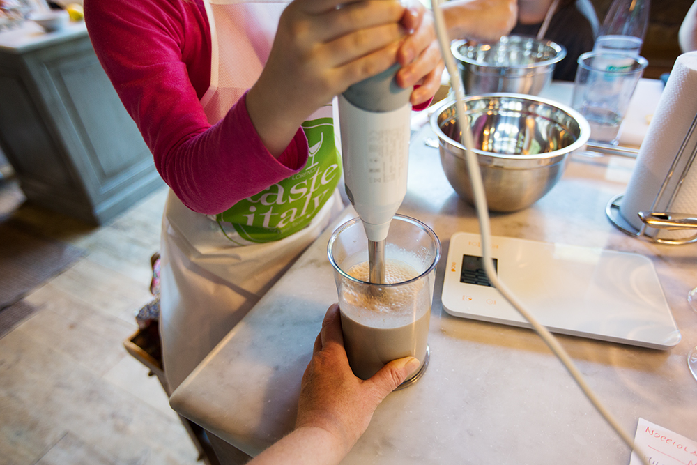girl using immersion blender