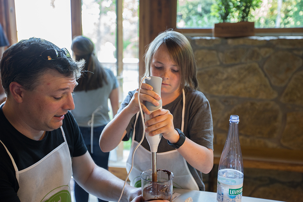 dad surprised as son uses immersion blender