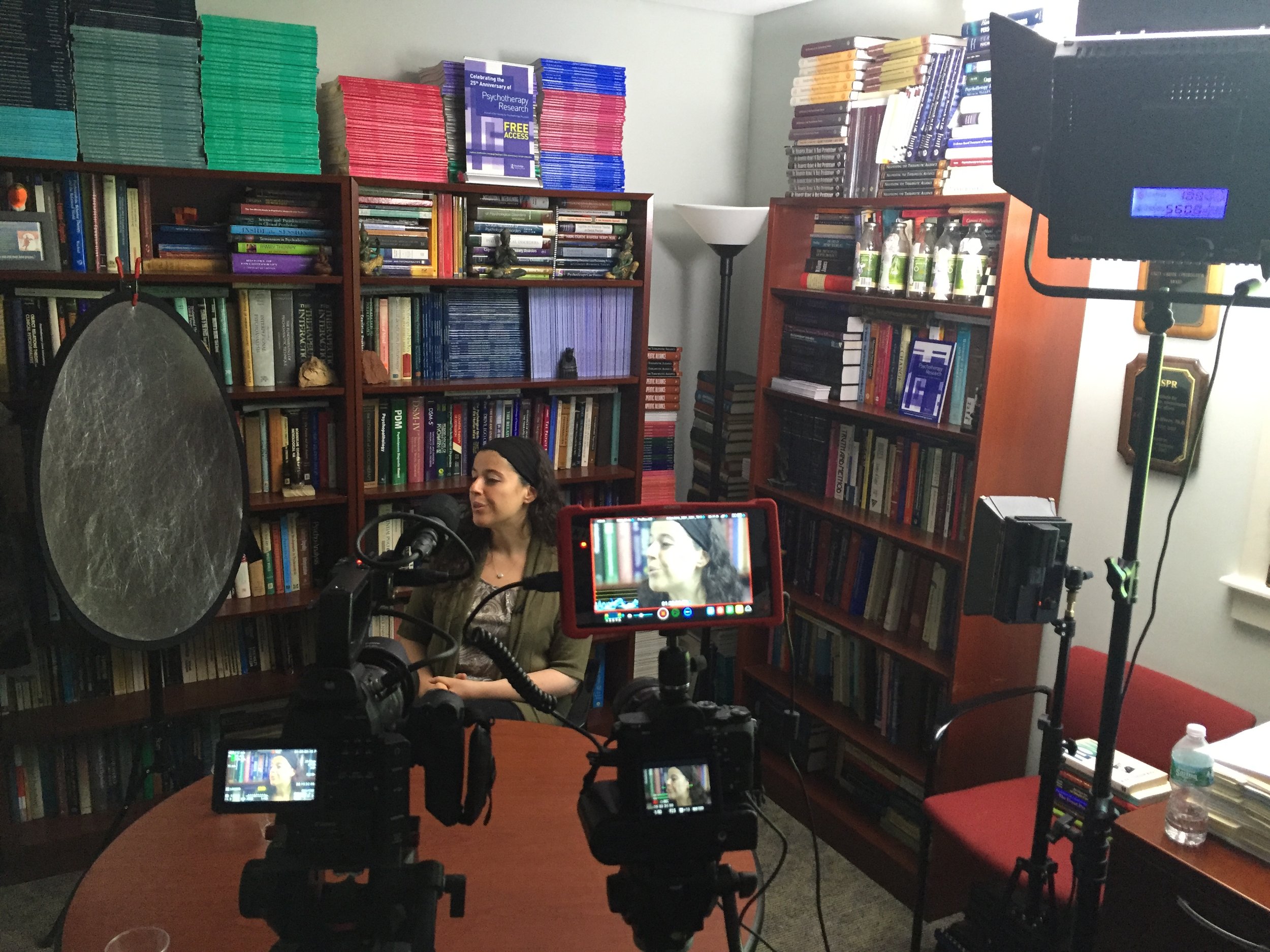 Two camera shoot with lighting in a windowless office.