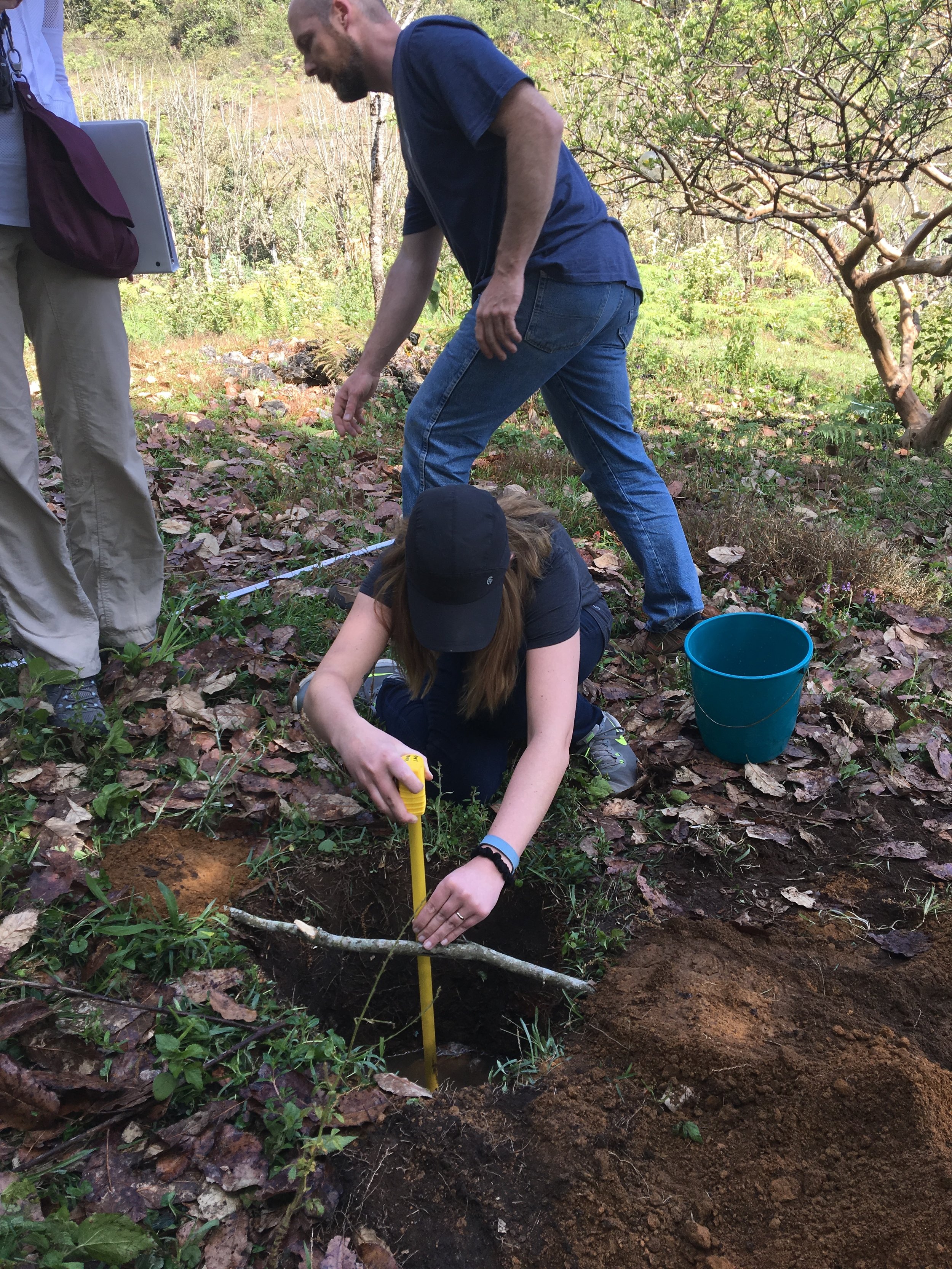 This is me, measuring water dropping in a test hole to come up with the sanitary percolation rate (in order to size the septic tank and soak pits).
