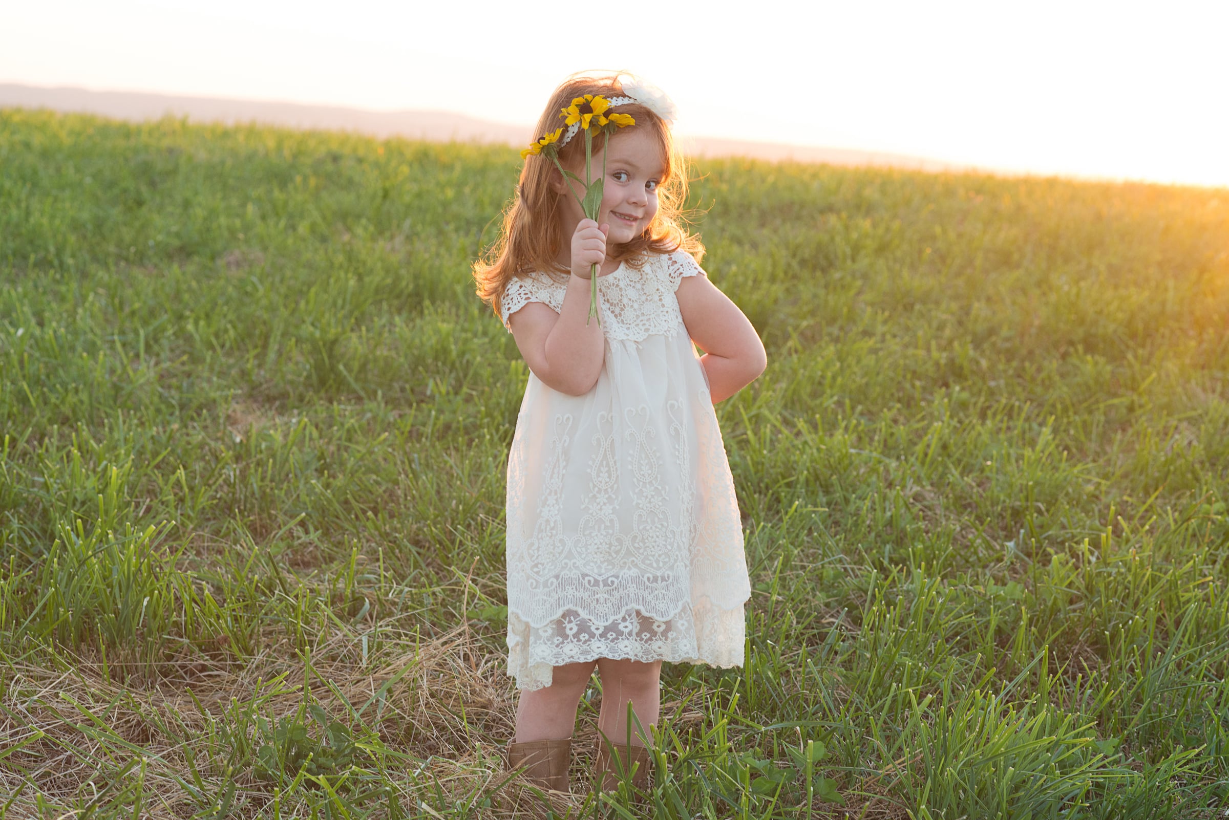 little girl at sunset in meadow