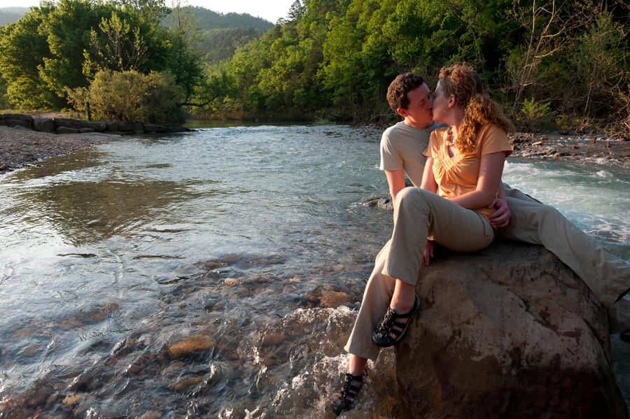 Couple kissing sitting on boulder in the Buffalo River