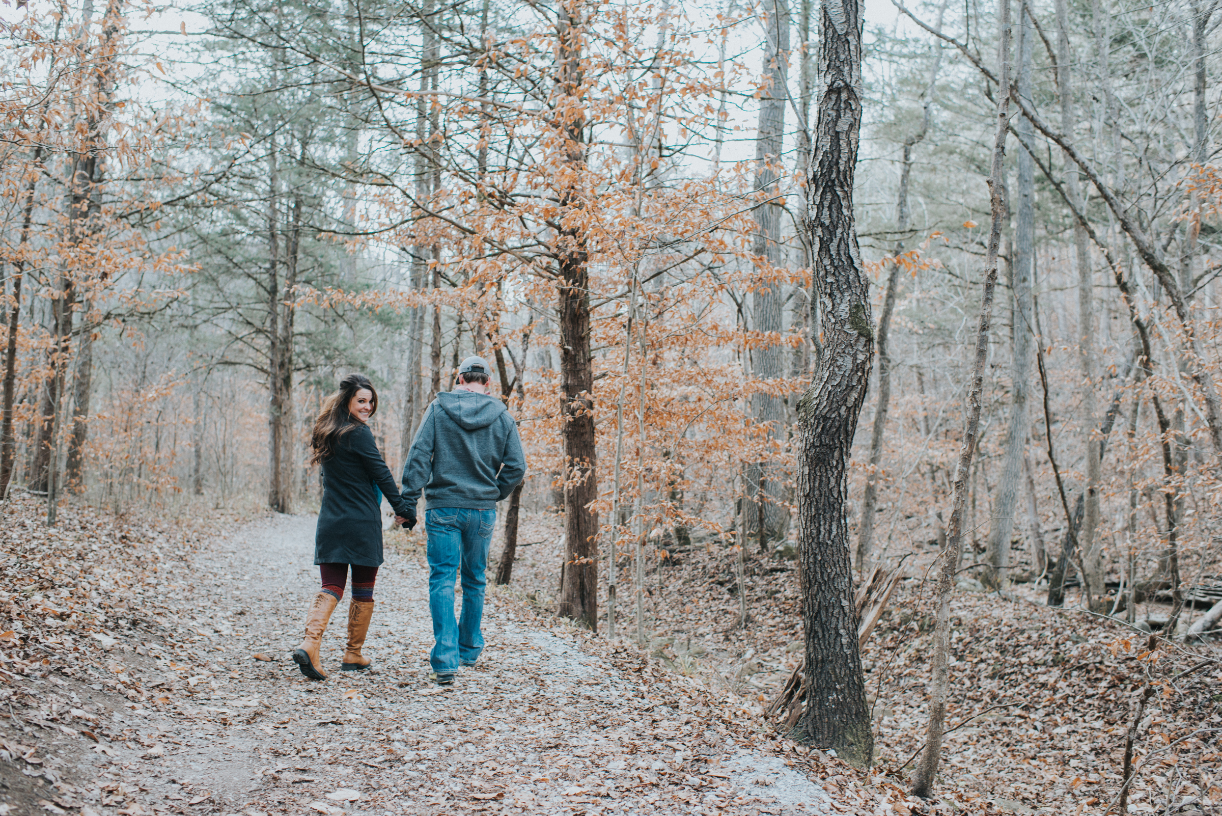 Couple walking in a wooded trail