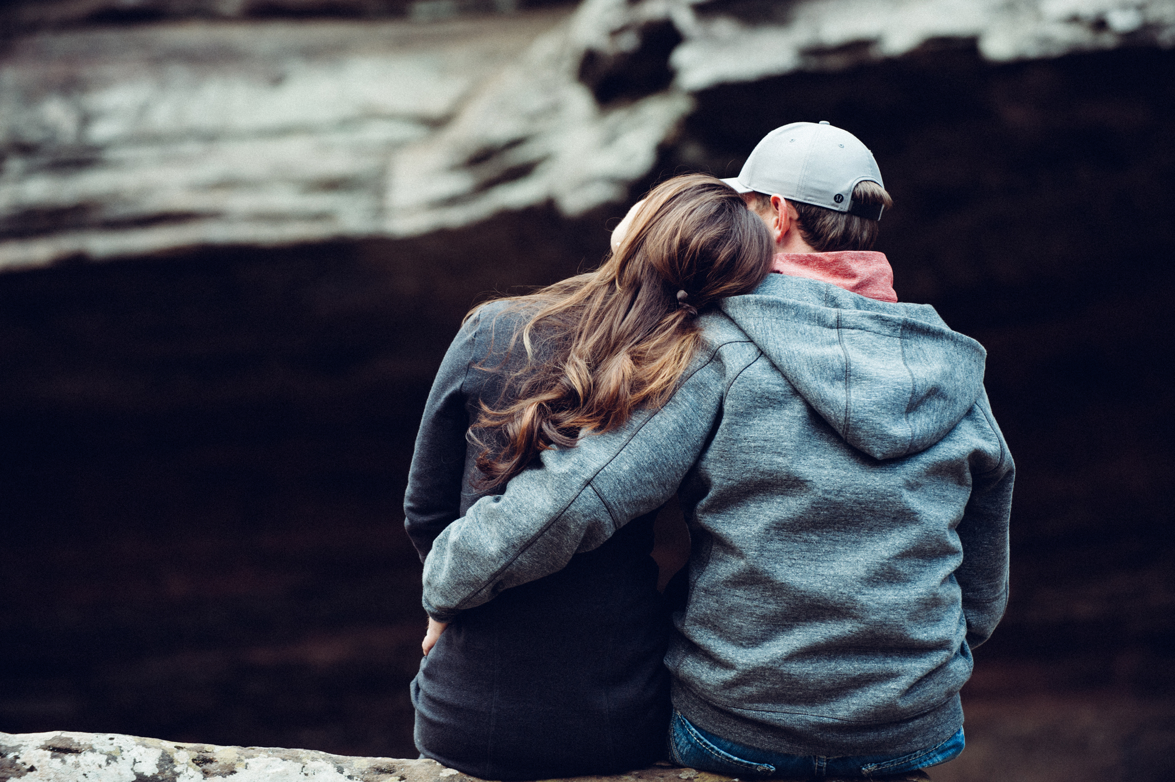 Couple sits among boulders