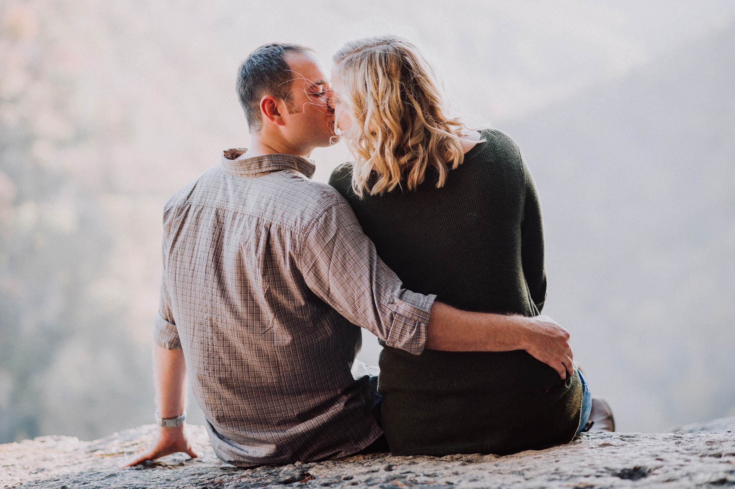 Couple shares a quiet moment at mountain top overlook