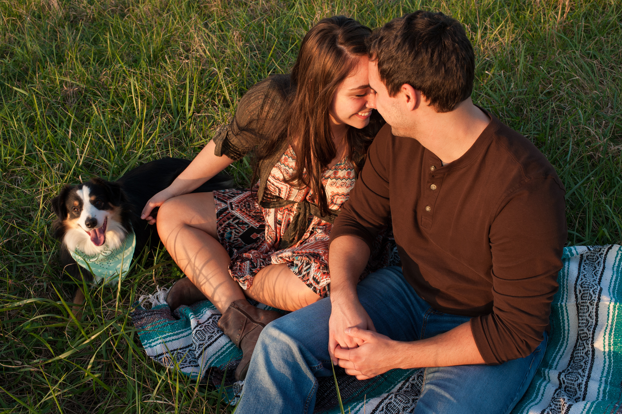 Couple together on ground with their dog