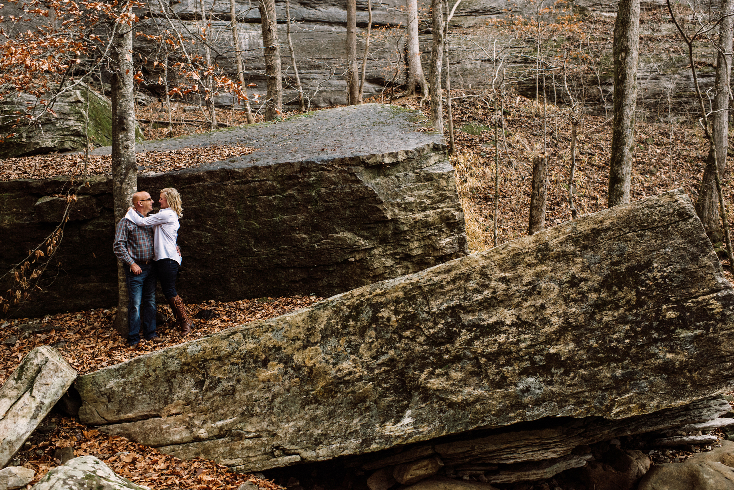 Couple among boulders in woods