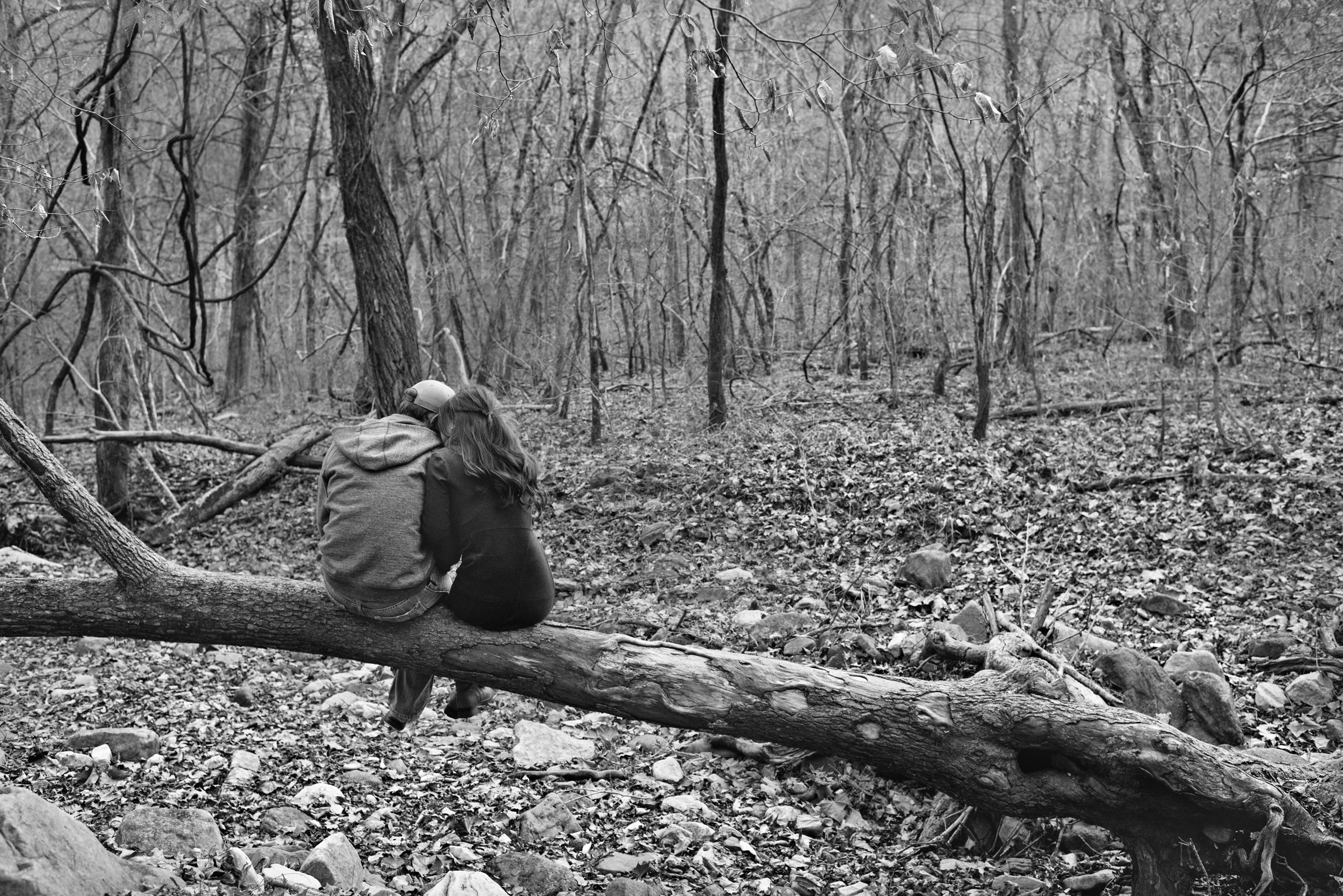 Engagement couple alone in woods