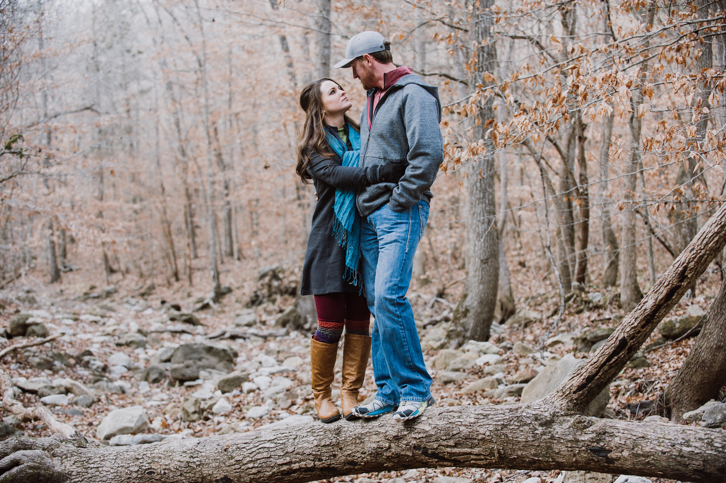 Engagement couple standing on a log