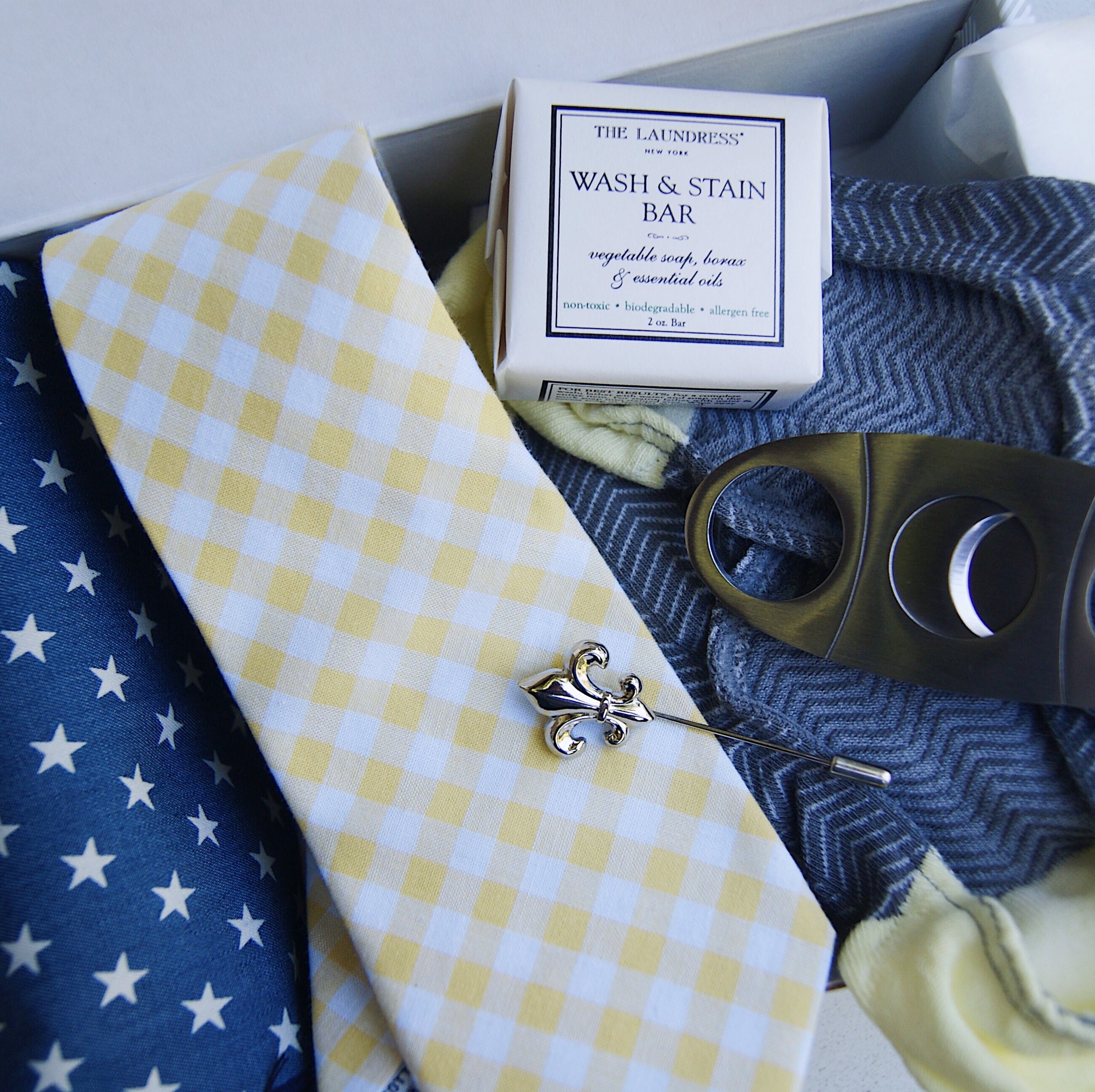 Some Sprezzabox goodies including a tie, pocket square, cigar cutter, pin, and socks. 