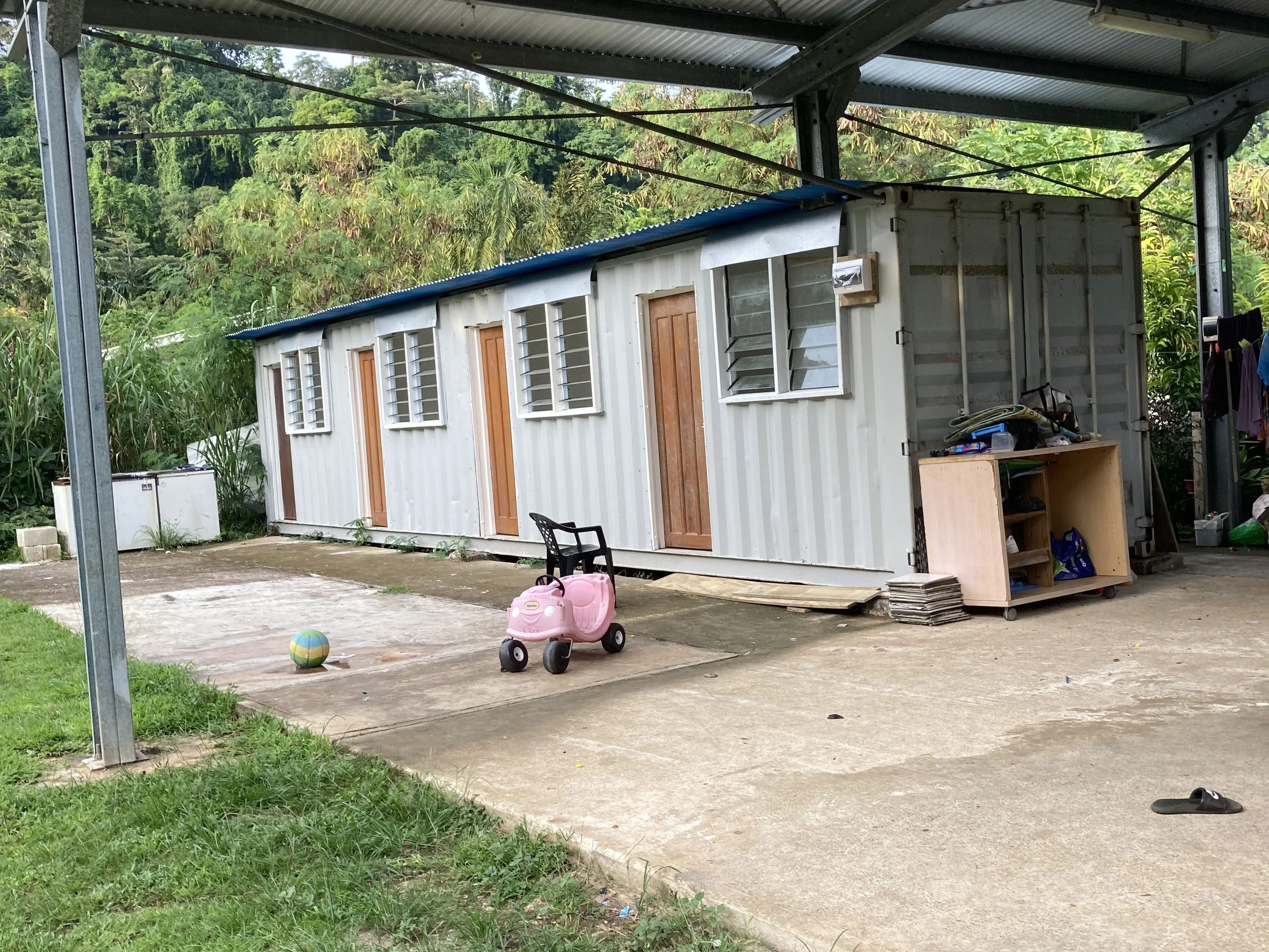 A shipping container with four doors and windows.