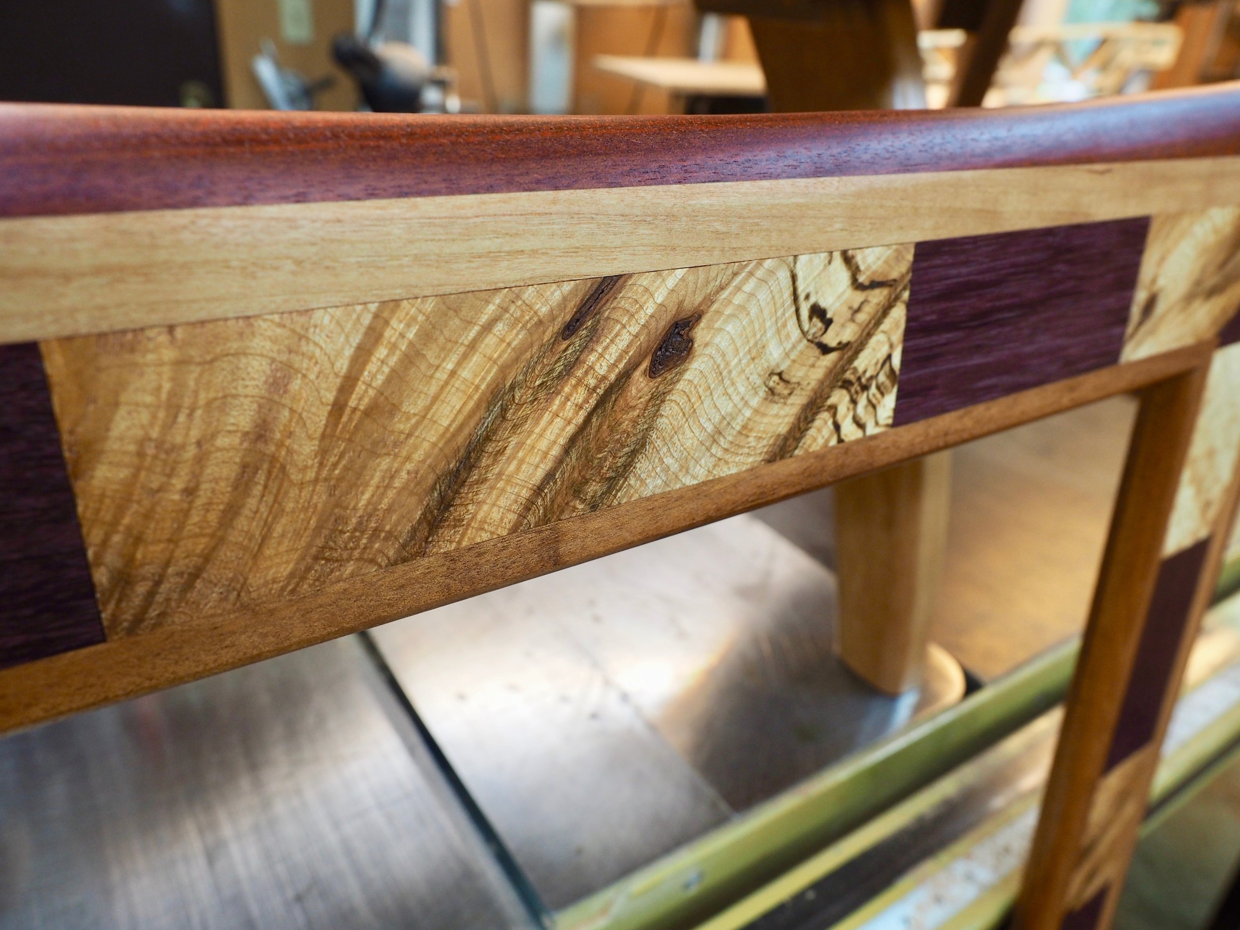 Here, one can see the full range of color on the mirror. From inside to outside - tiger wood (goncalo alves), maple burl and purple heart, cherry, and bloodwood.