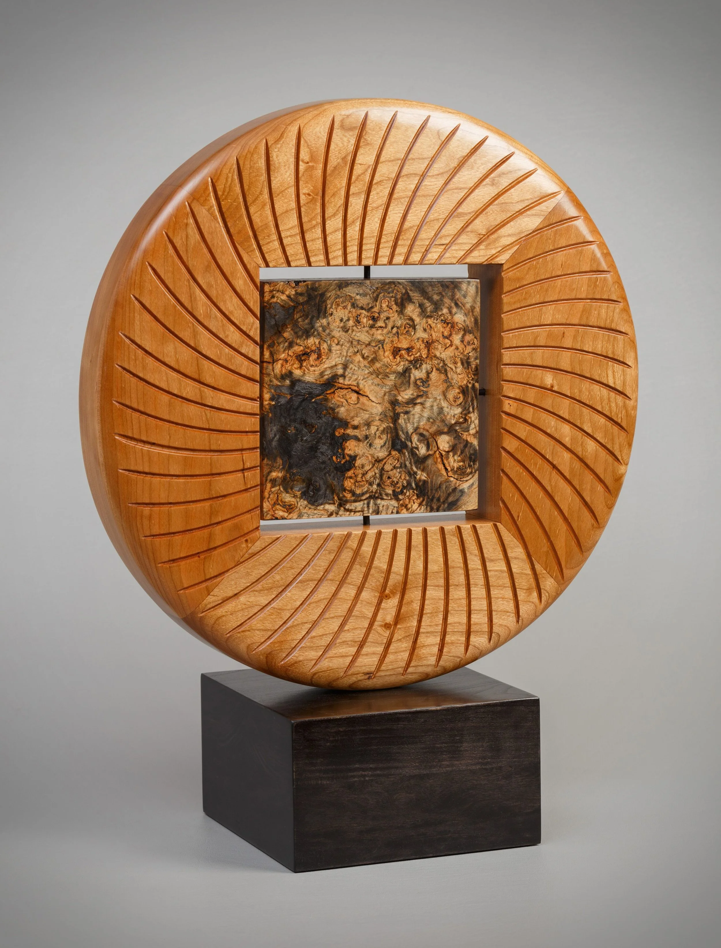 Burl Sun Disc - 16” diameter x 2” deep. Cherry and toasted maple burl, finished in tung oil.