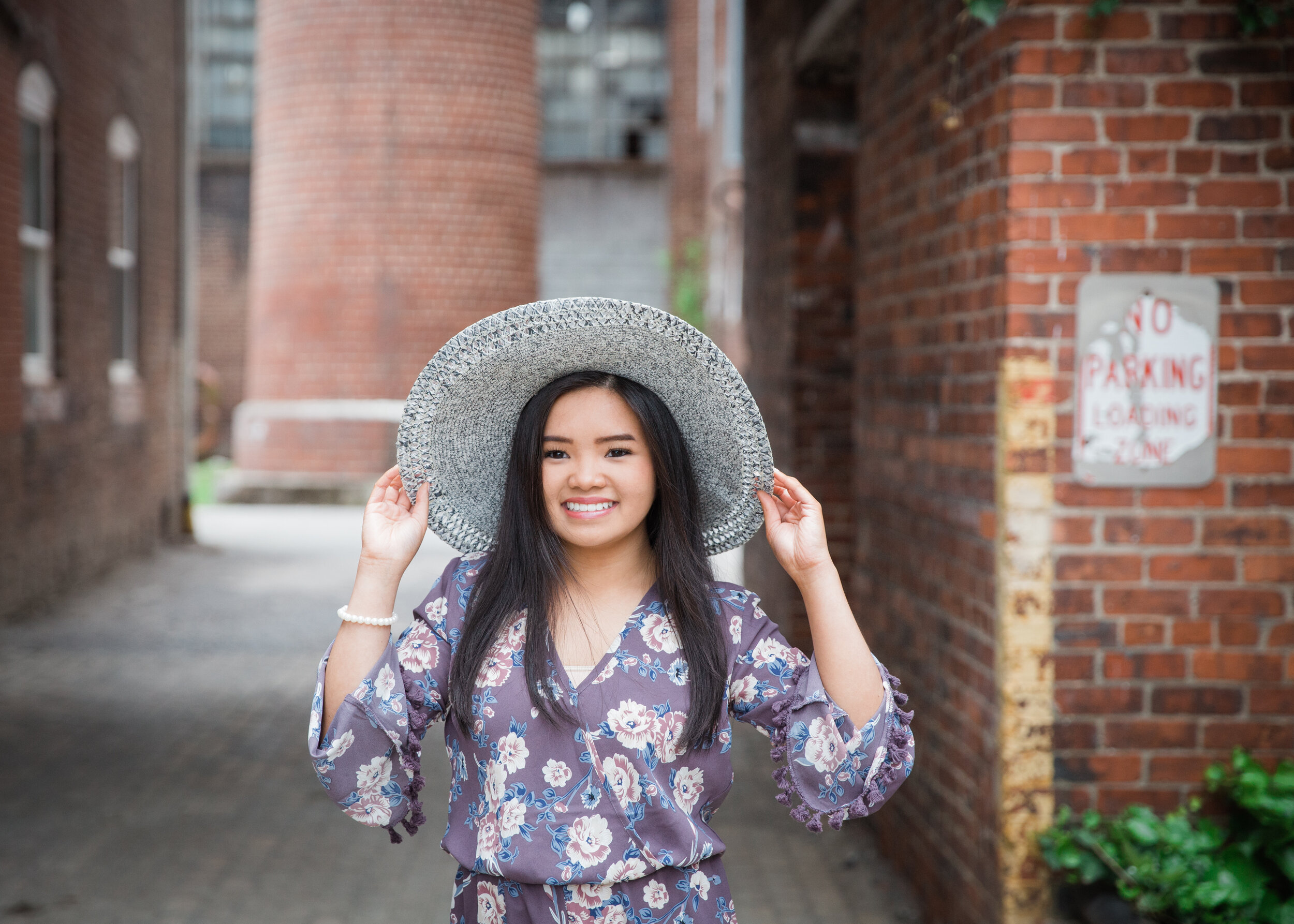 high school senior with a floppy hat at the old woolen mill in Cleveland Tennessee