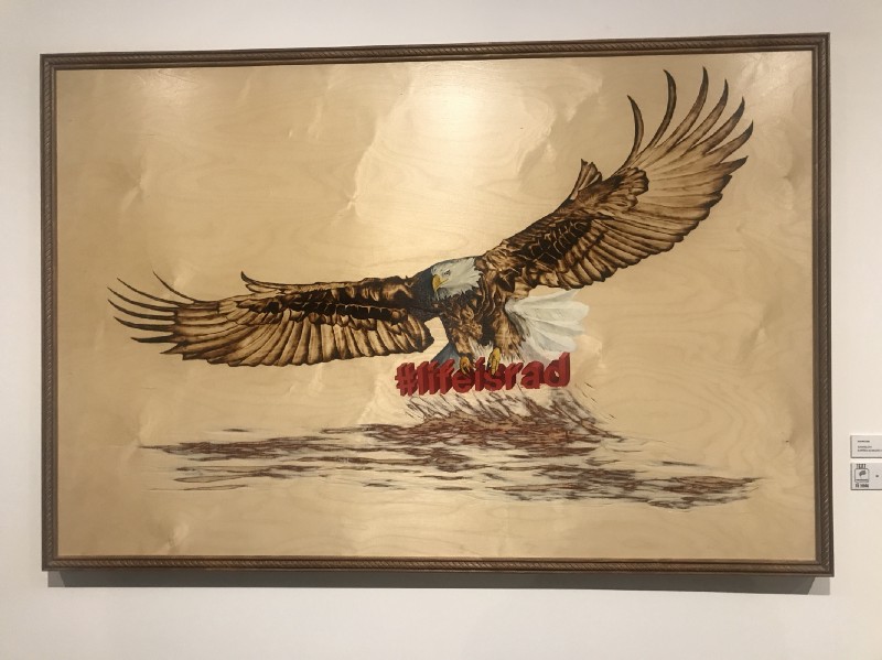 Artist: Ryan McCann, #LifeisRad, 2015. Blowtorch, oil and acrylic on wood