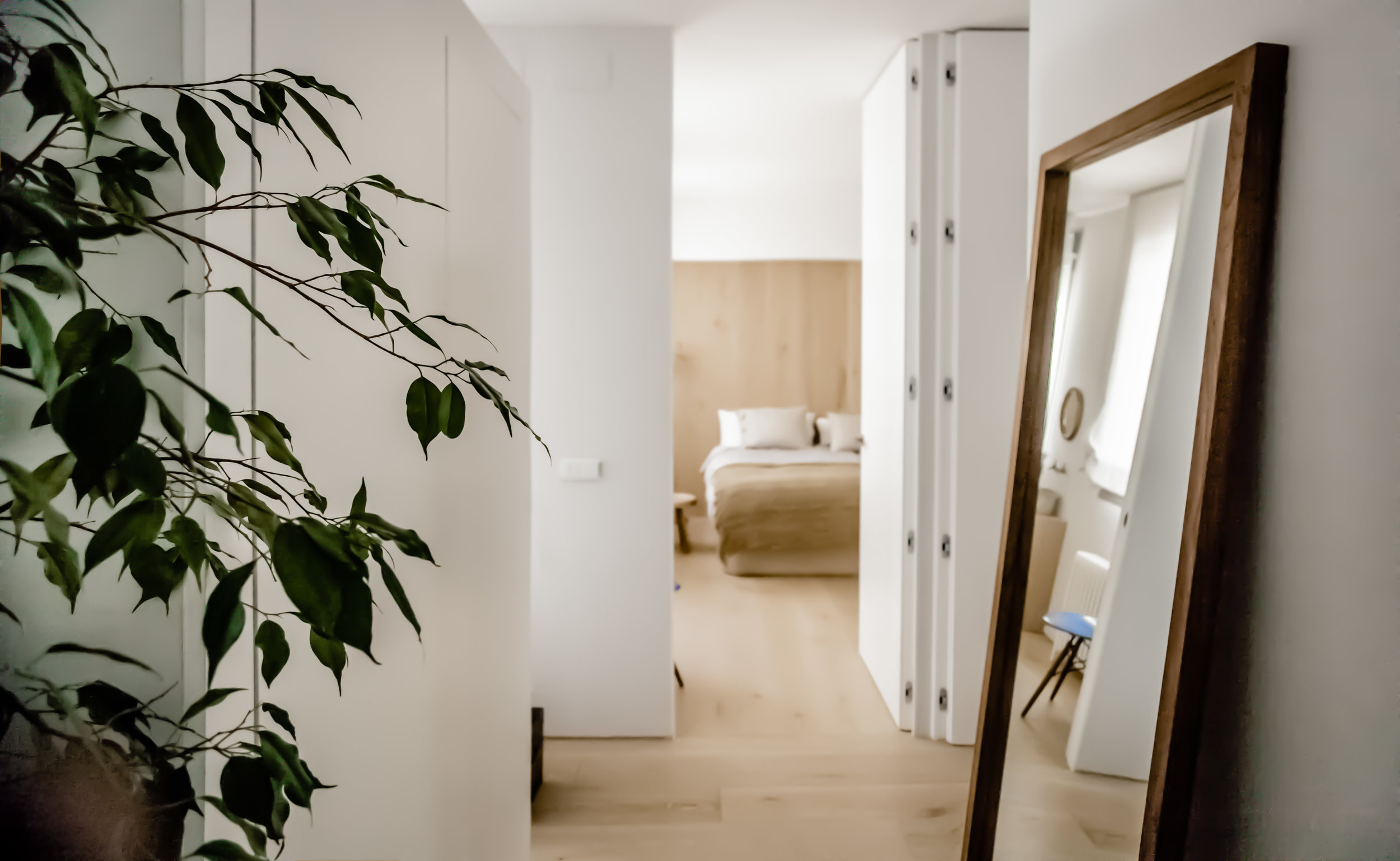 In the initial design phases on the Oak Residence project Quiet Studios observed the client’s routines and customs to create a space tailored to her needs. Where once small rooms stood a new layout allows natural light to flood through the property. Iron pillars segment the space, unobtrusively dividing the large common room, open kitchen, dining room and living room overlooking the terrace. Oak is the primary material of the house, the client’s favourite hardwood. Covering the walls and floors of the living spaces, kitchen and bedrooms, the oak gives a sleek finish to integrated storage solutions, adding a minimalist facade to shelves and closets. The uncovered walls are painted in a powder grey, broadening the space and adding a fresh contrast to the rich wood tones of the oak and teak furniture. Bringing bespoke design elements together with high-quality pieces the space has a luxurious and personalised feel. Collaboration: LBMP Arquitectos