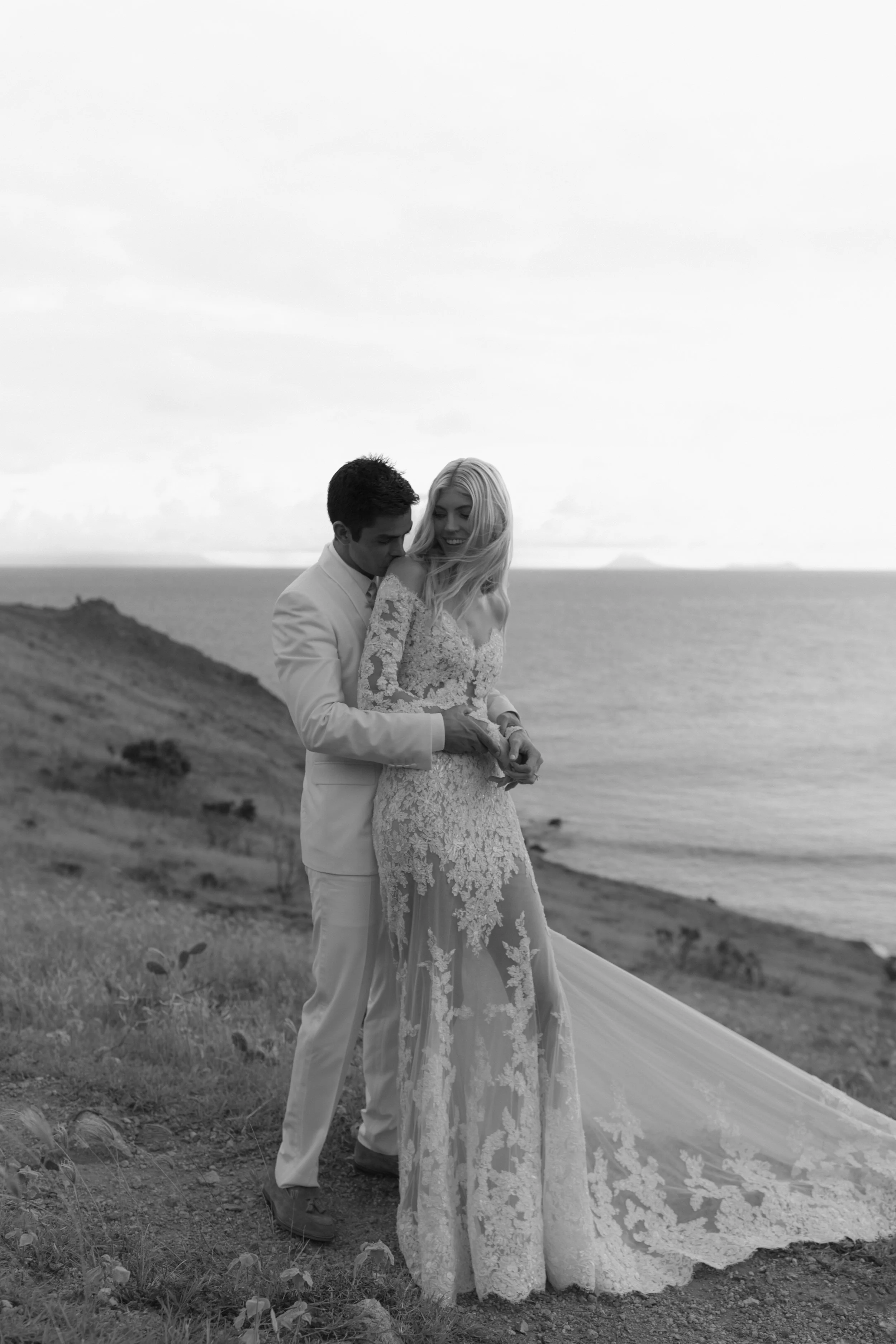 Wedding photography by Melissa Marshall featuring Devon Windsor, a coast portrait in Saint Barthelemy, and a candid kiss celebration.